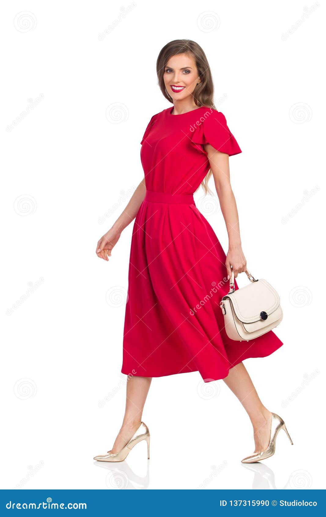Walking Beautiful Woman in Red Dress, Gold High Heels and Beige Purse ...