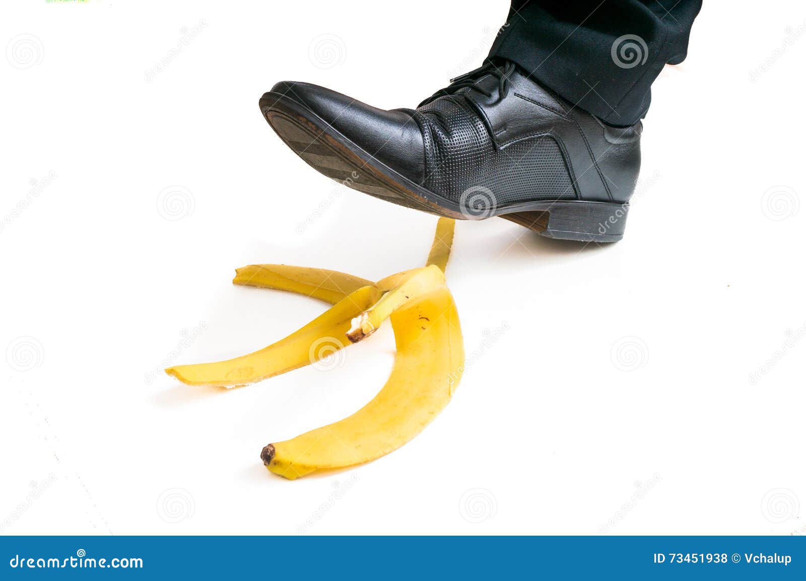 walking businessman is going to slip on banana peel