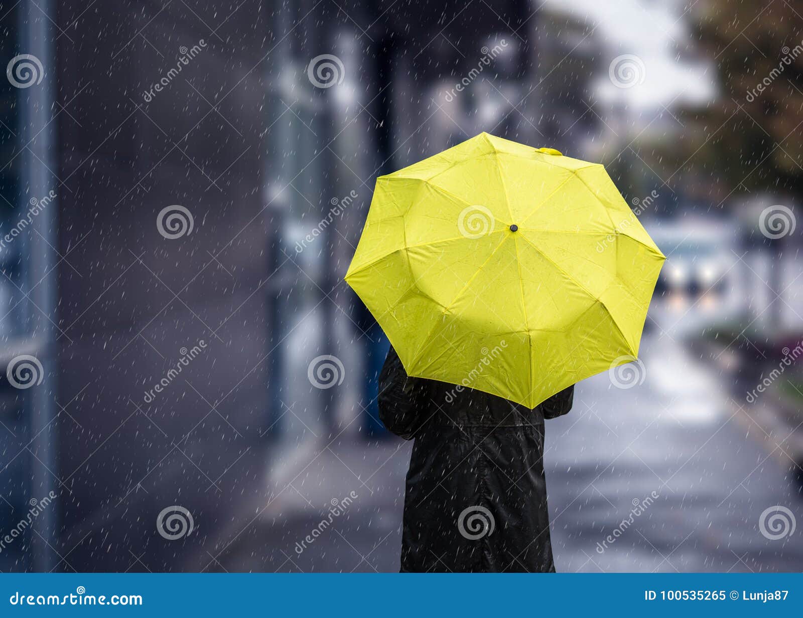 walking on rainy day with yellow umbrella