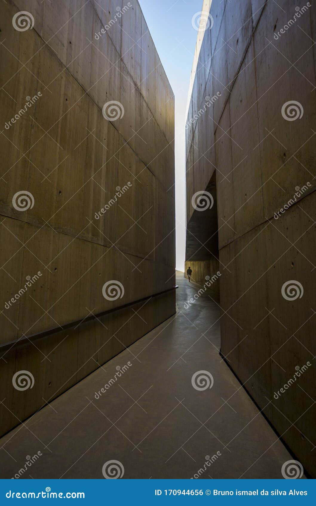 walking to the light between big walls in vila nova de foz coa museum.