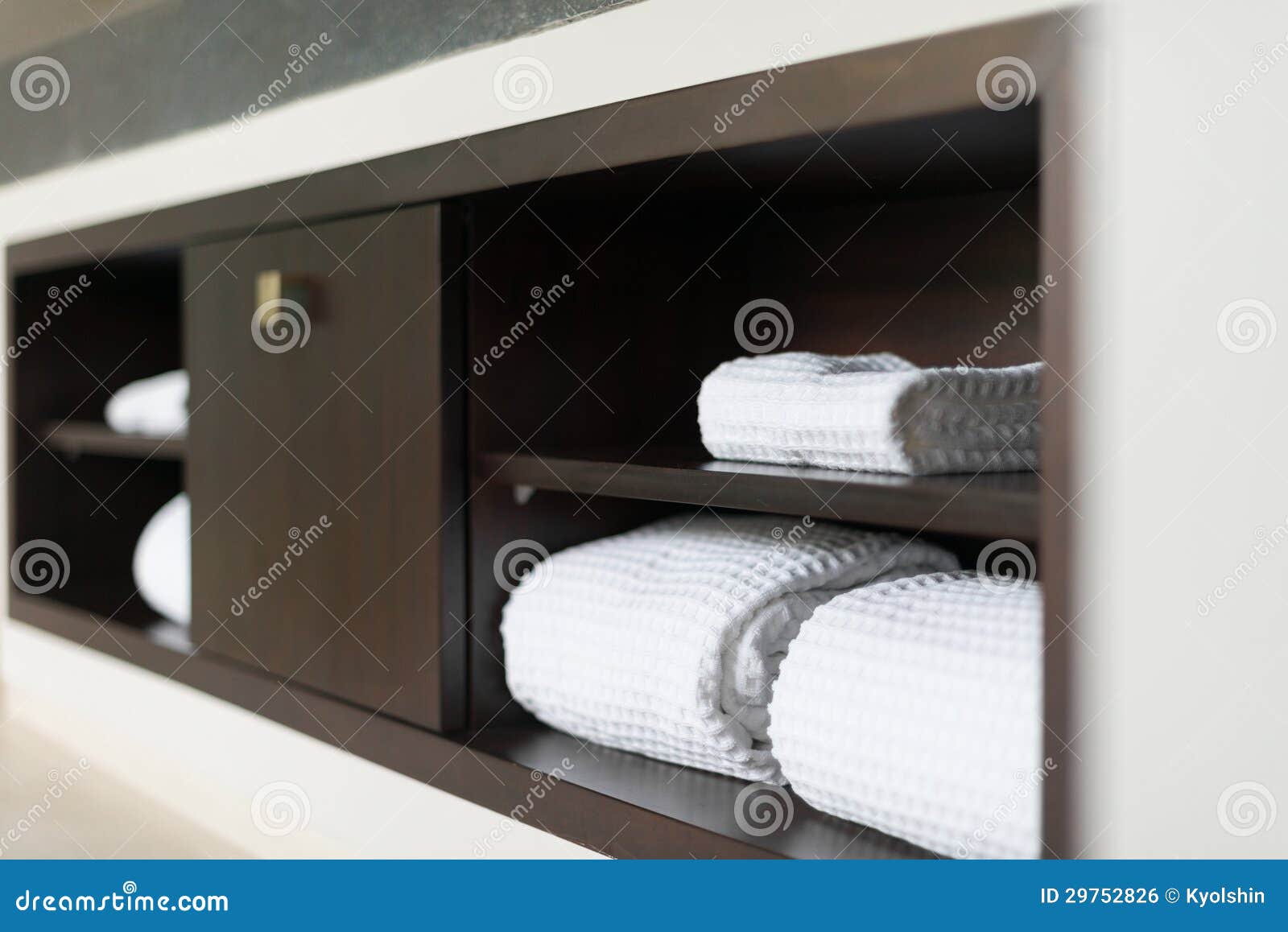 Rolled White Towels On Shelf In Hotel Bathroom Stock Photo