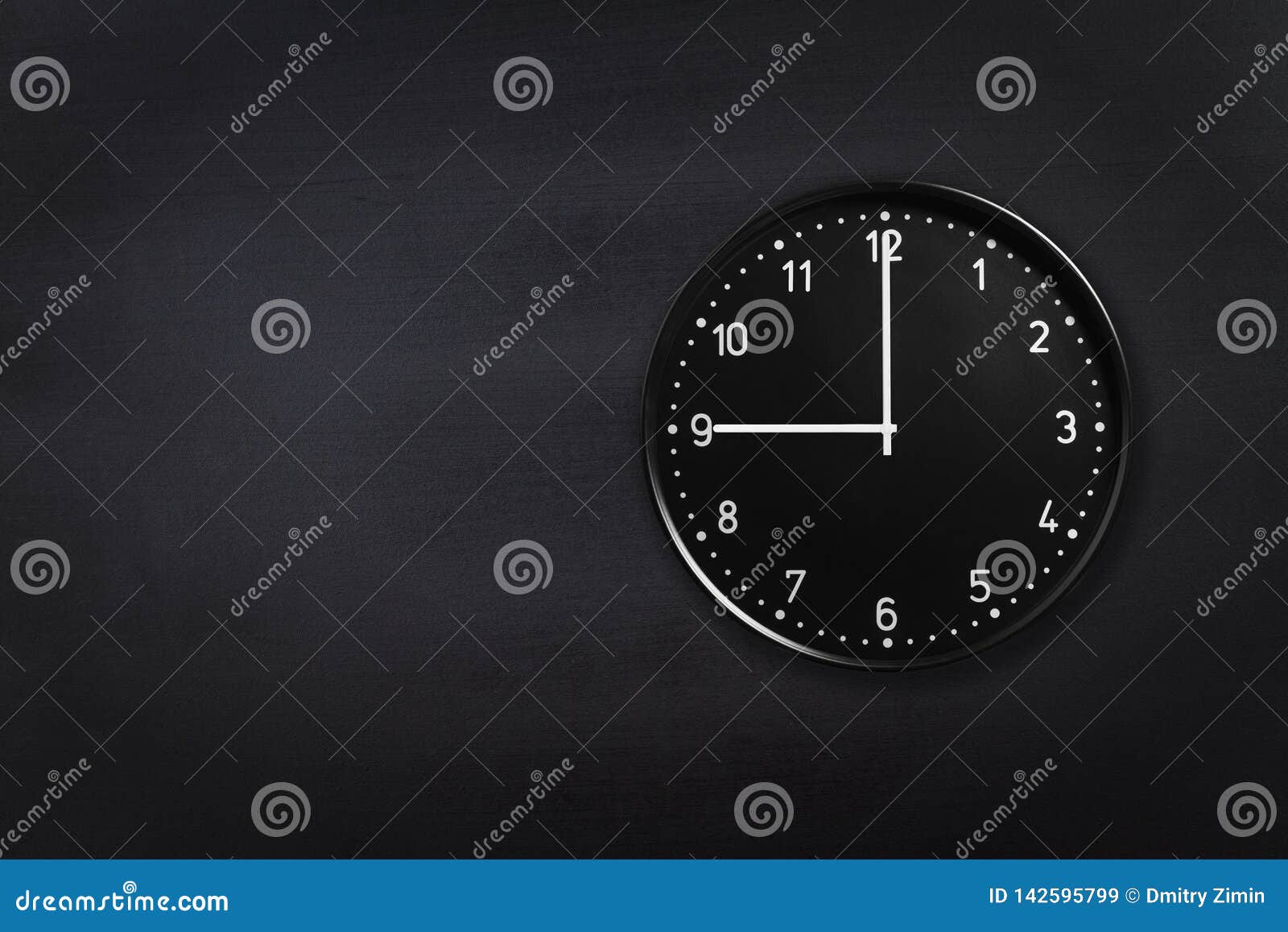 wall clock showing nine o`clock on black chalkboard background. office clock showing 9am or 9pm on black texture