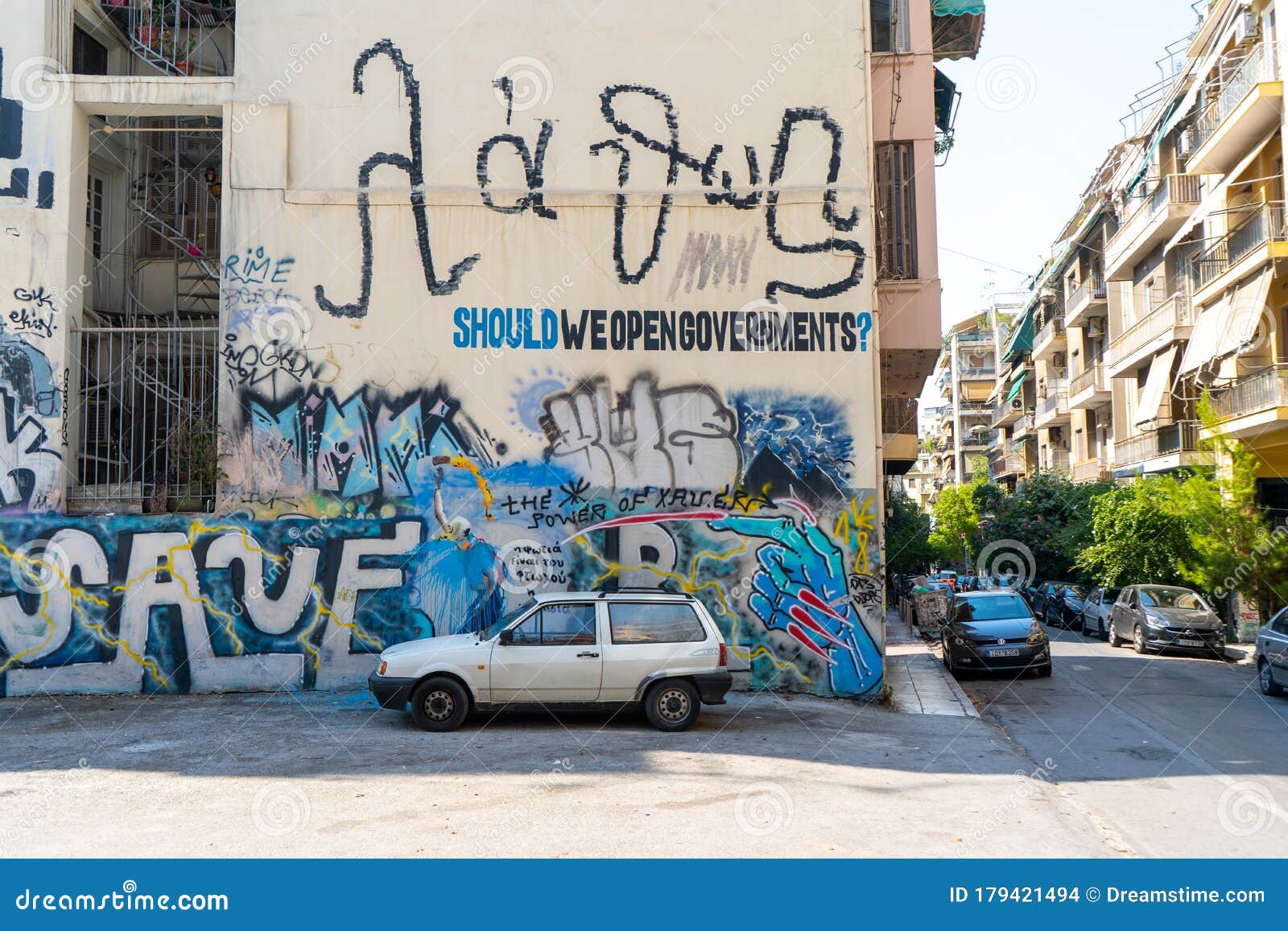 Wall with Graffitis and Old Car in Athens, Greece. August 2019
