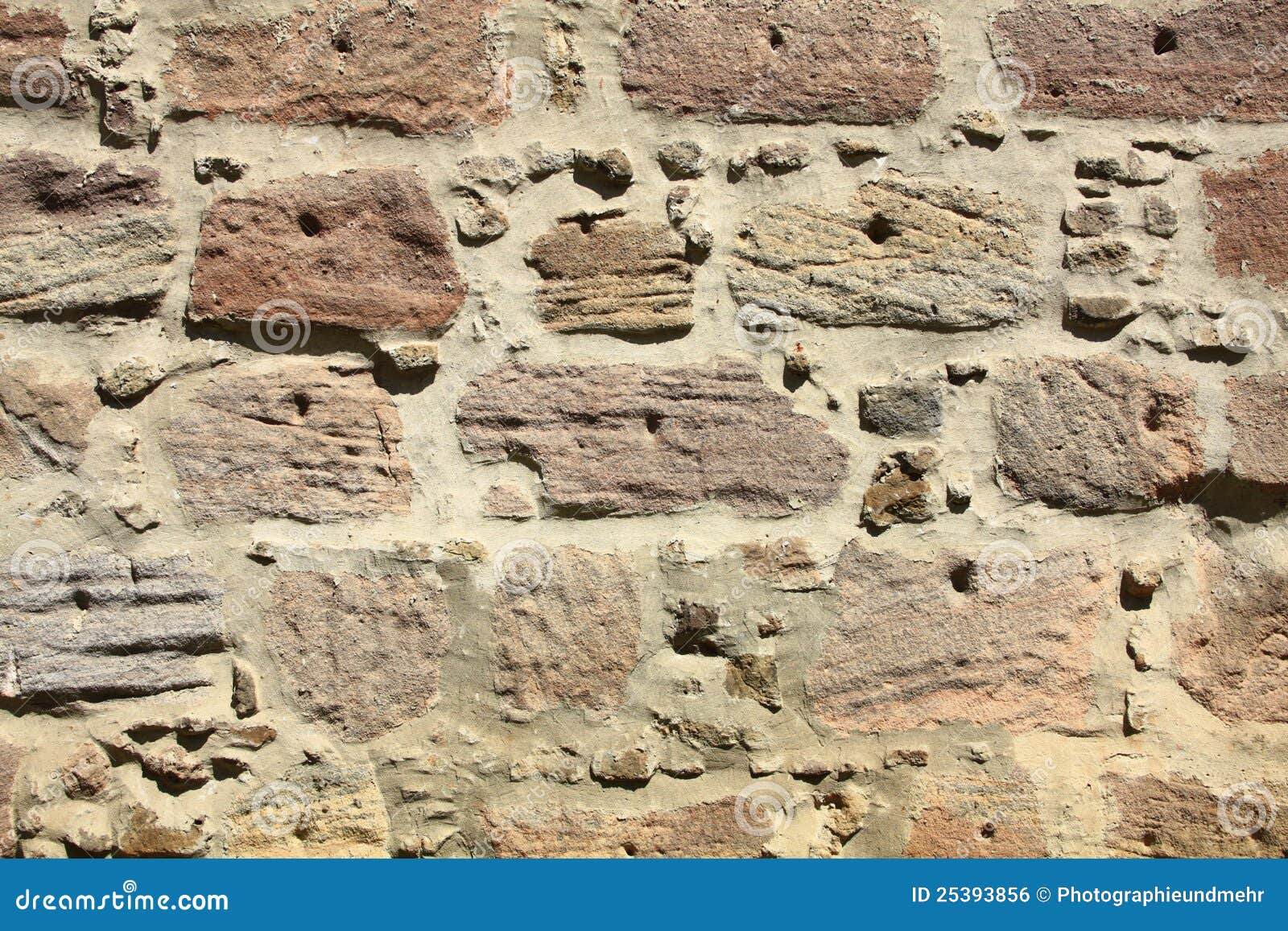 Wall made of natural stones. Decorative old weathered wall, made of natural stones