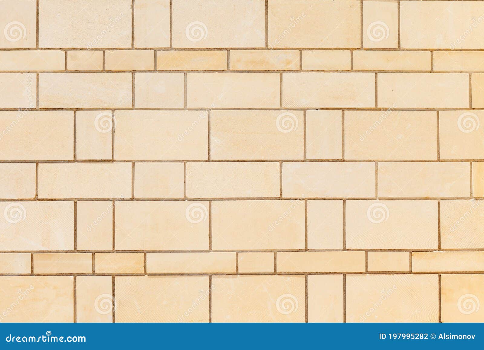 wall made of smooth, rectangular yellow sandstone blocks. background image, texture