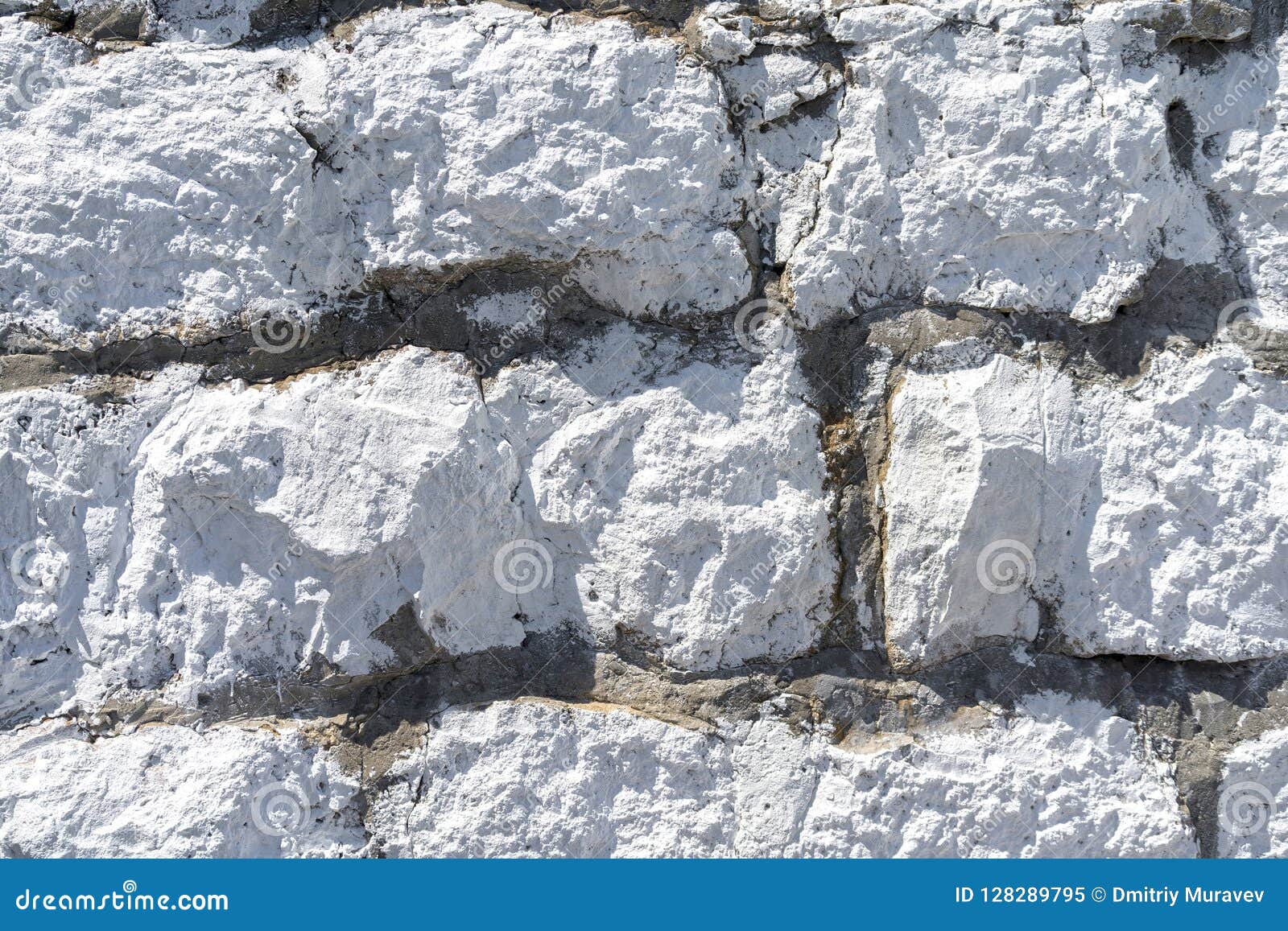 Wall of White Limestone Cobblestones. Natural Materials in Construction