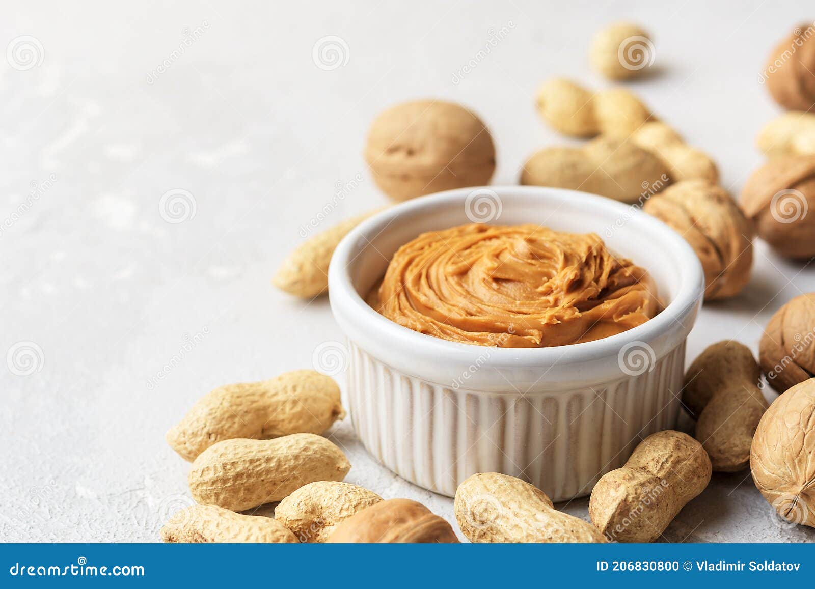 Walnut Butter Made of Peanuts, Almonds and Walnut on a Grey Background