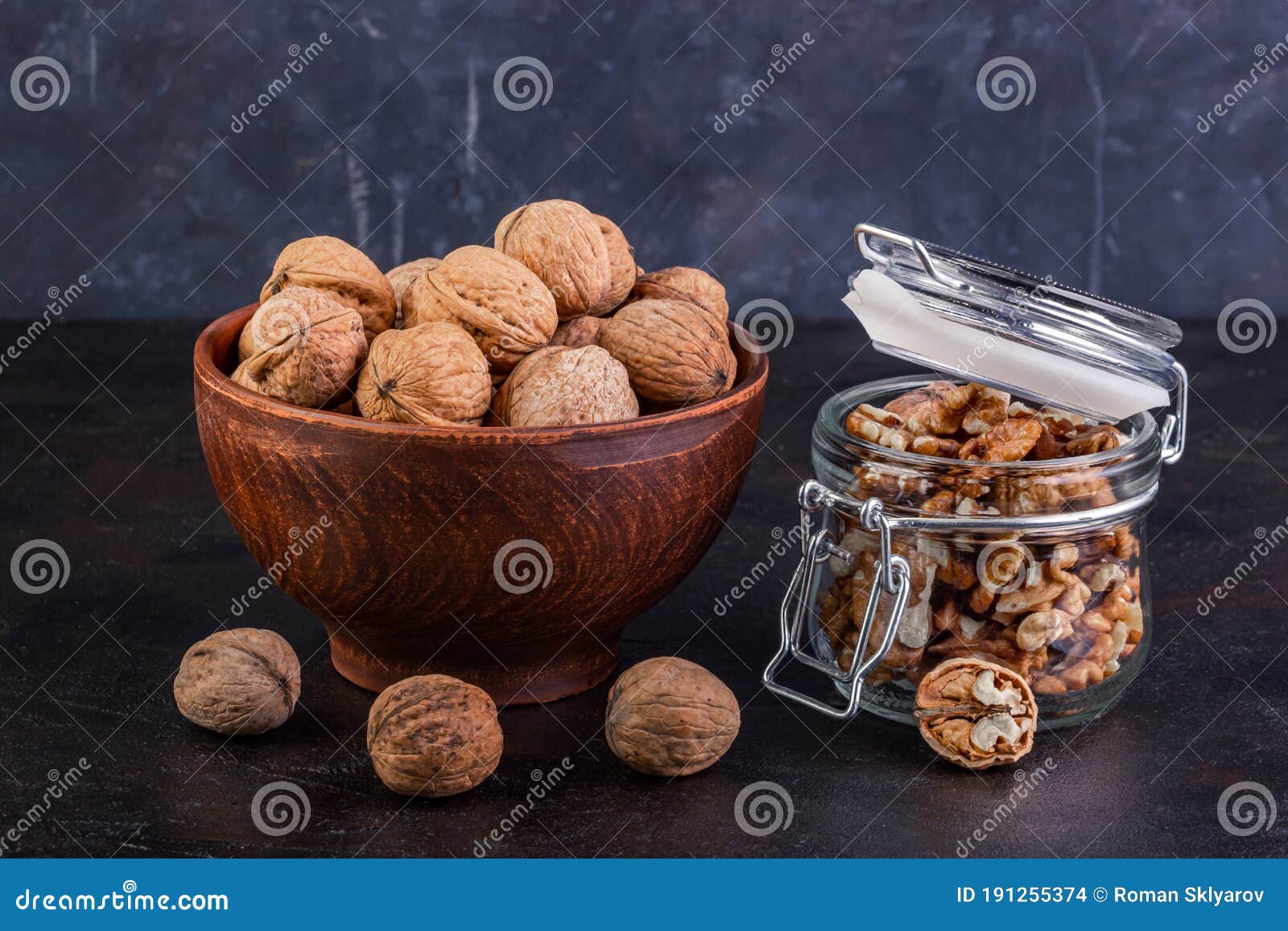 walnut in a clay bowl and glass jar