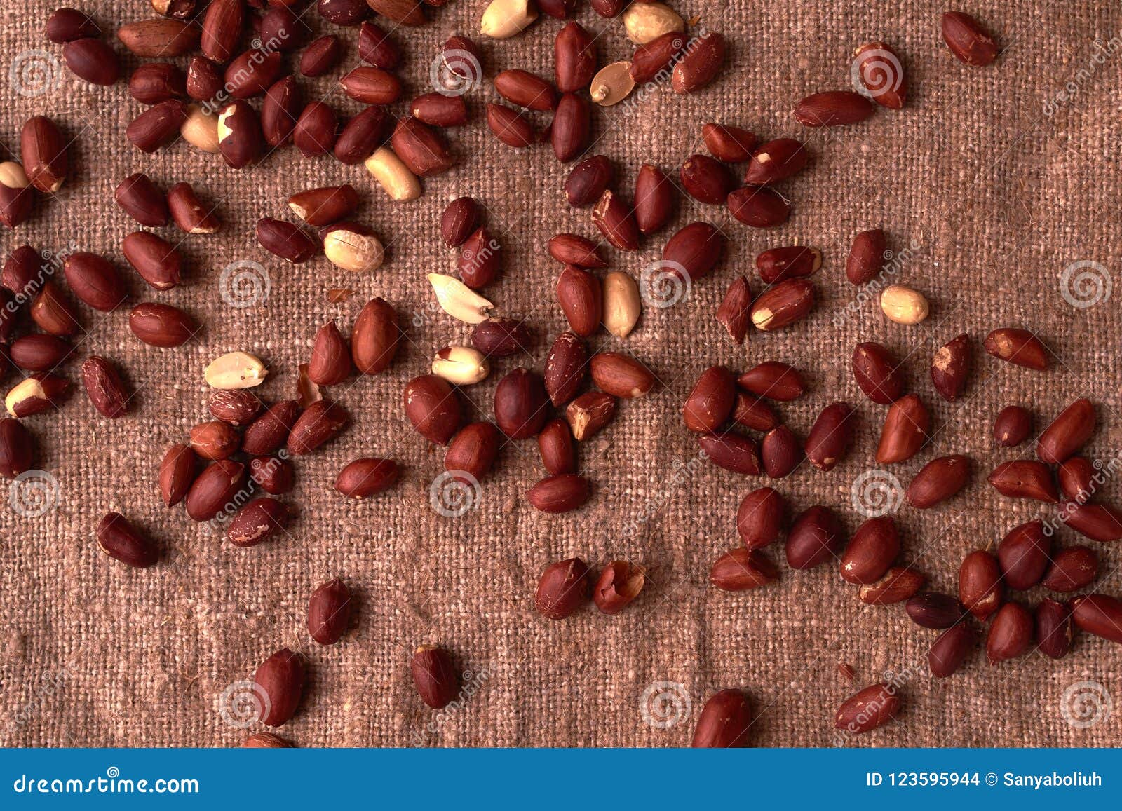 walnut peanut scattered on sackcloth background. top view. textured