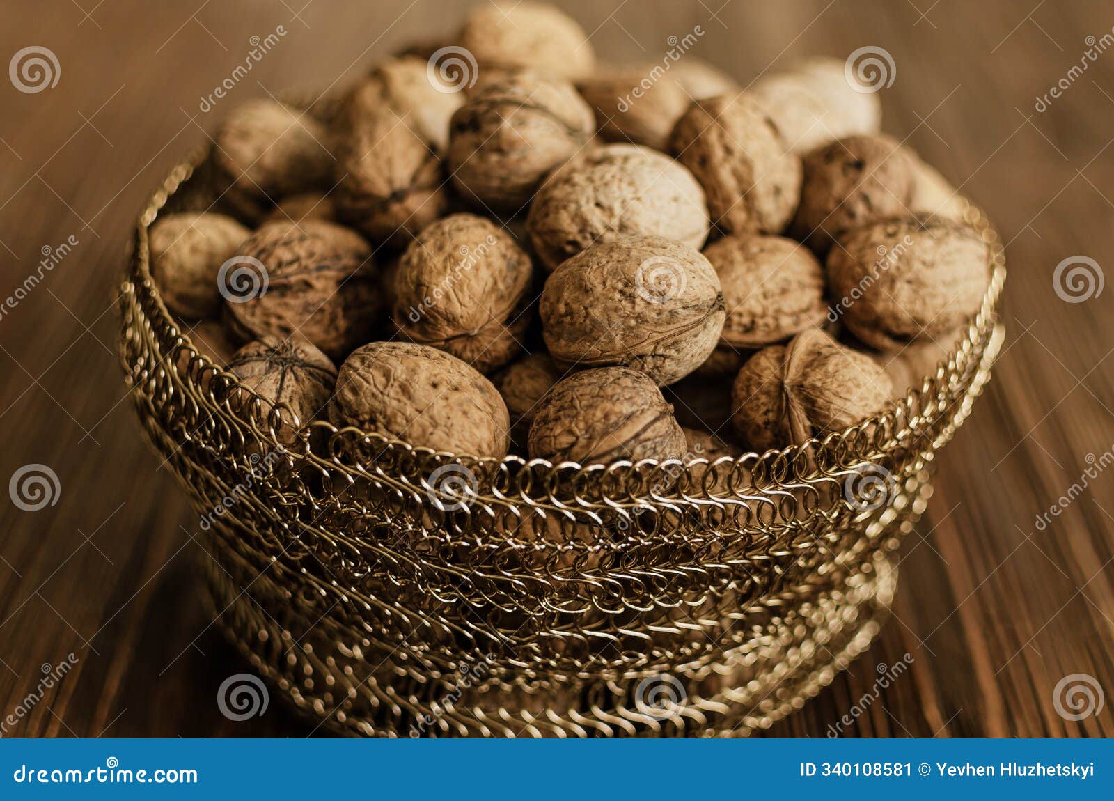 walnuts in a wickerbasket on wood