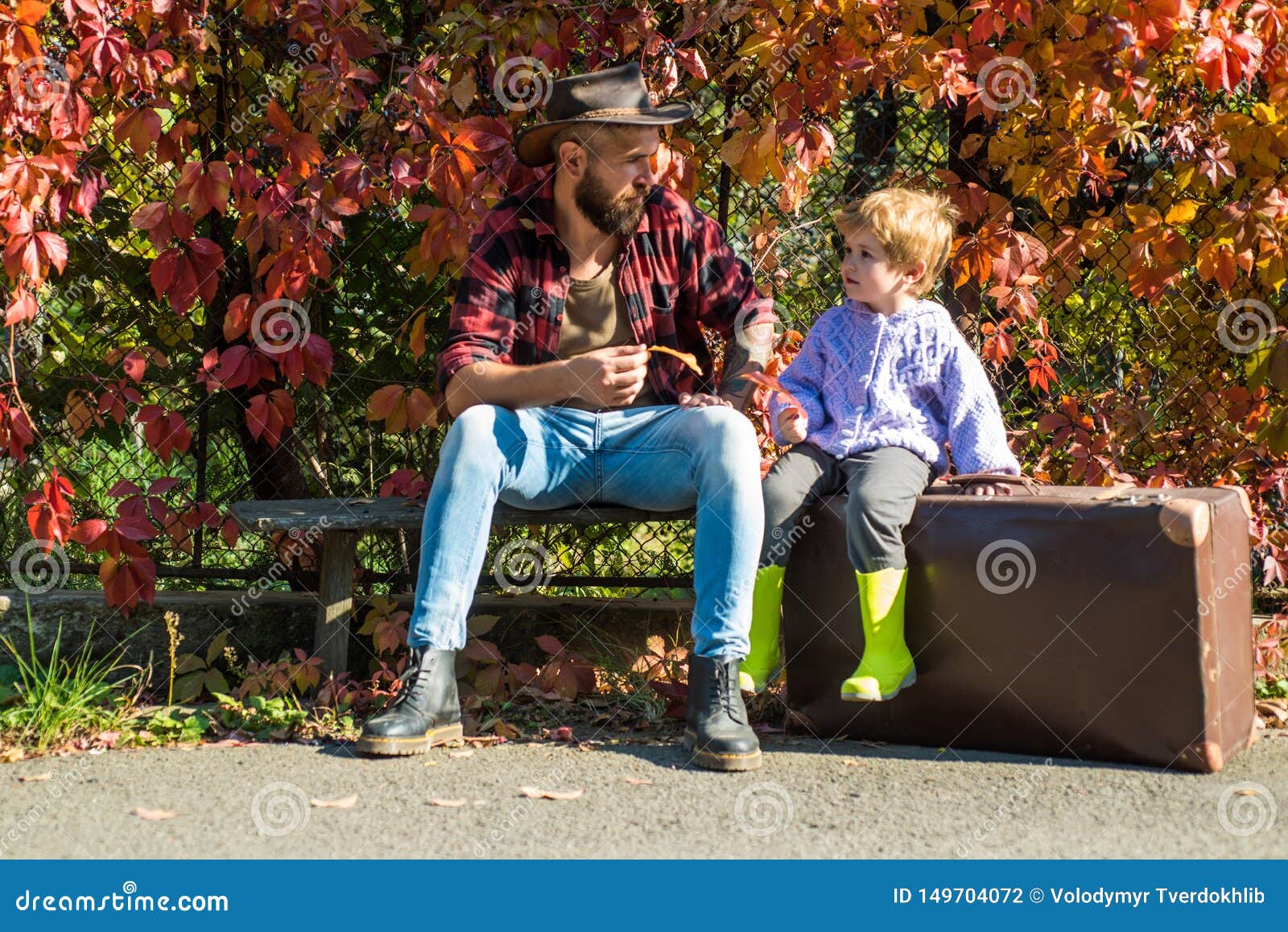 wanderlust concept. adventure with son. telling stories about past times. father with suitcase and his son. bearded dad