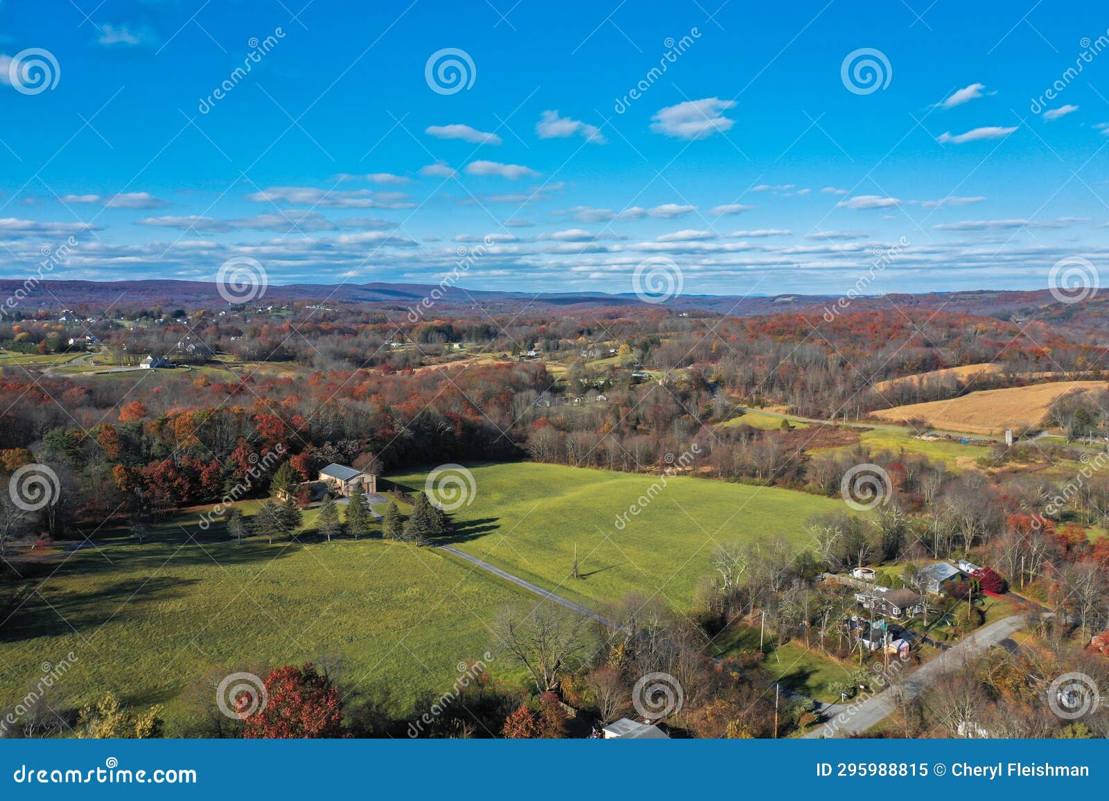 wantage nj farmlands with kittatiny mountain ridge and high point monument in distant on sunny autumn day with fall foliage aerial