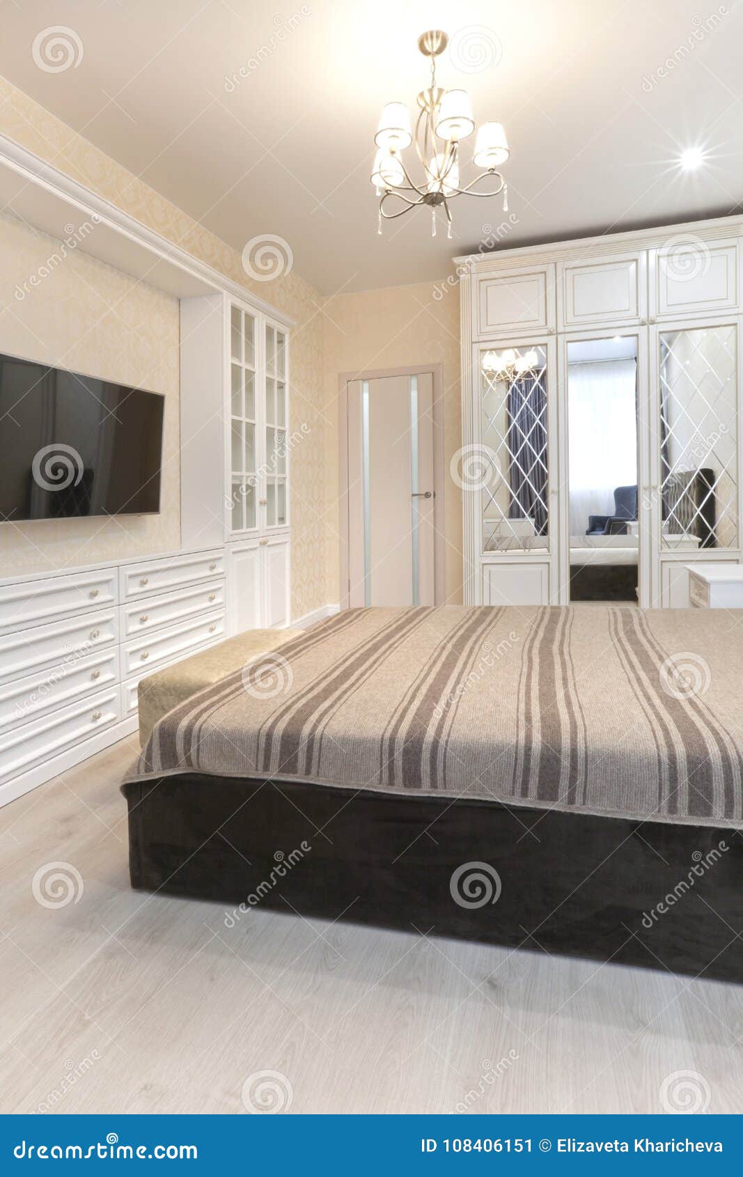 Bedroom In Light Colors With Wooden Furniture Stock Image