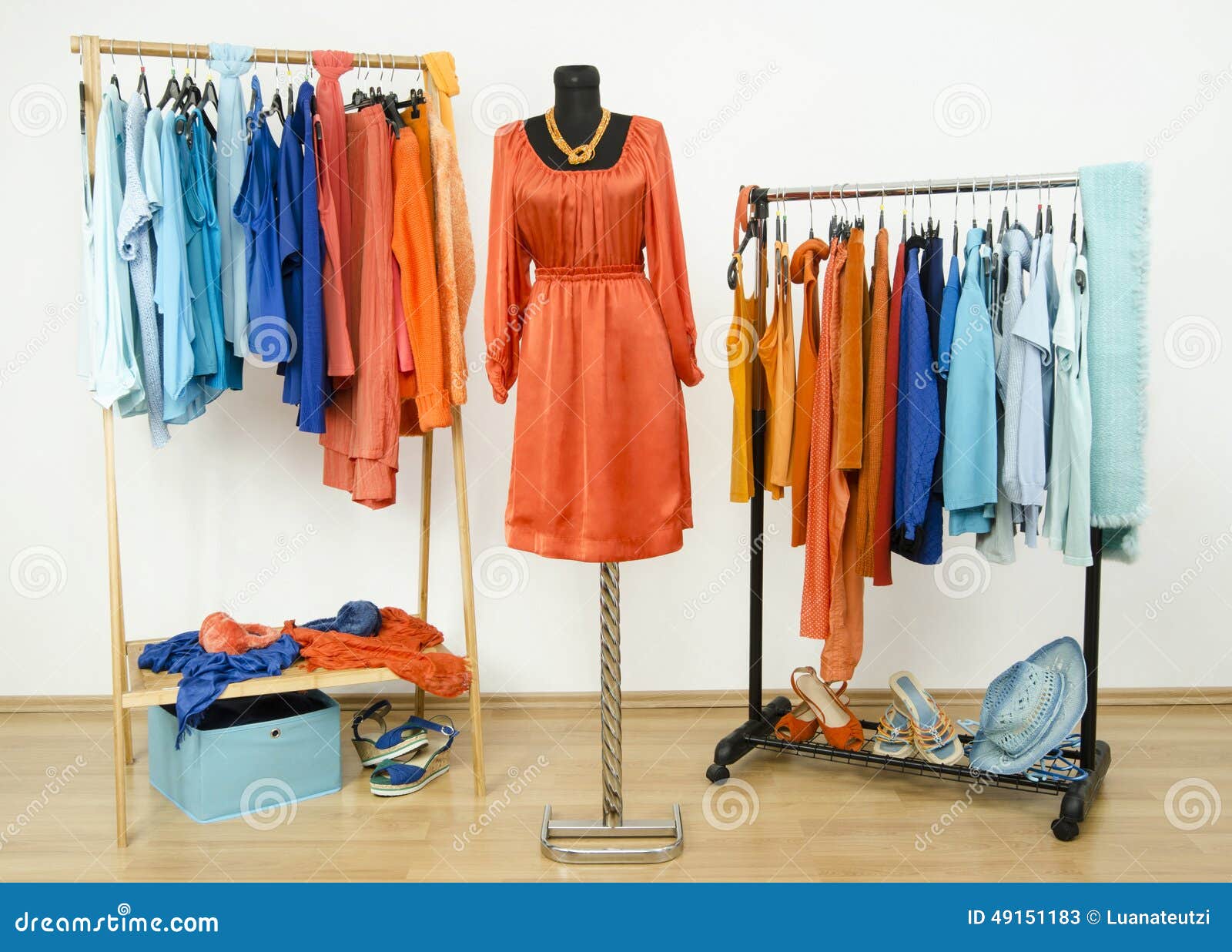 Wardrobe With Complementary Colors Orange And Blue Clothes Arranged On  Hangers. Dressing Closet With Clothes, Shoes And Accessories And A Dress On  A Mannequin. Stock Photo, Picture and Royalty Free Image. Image