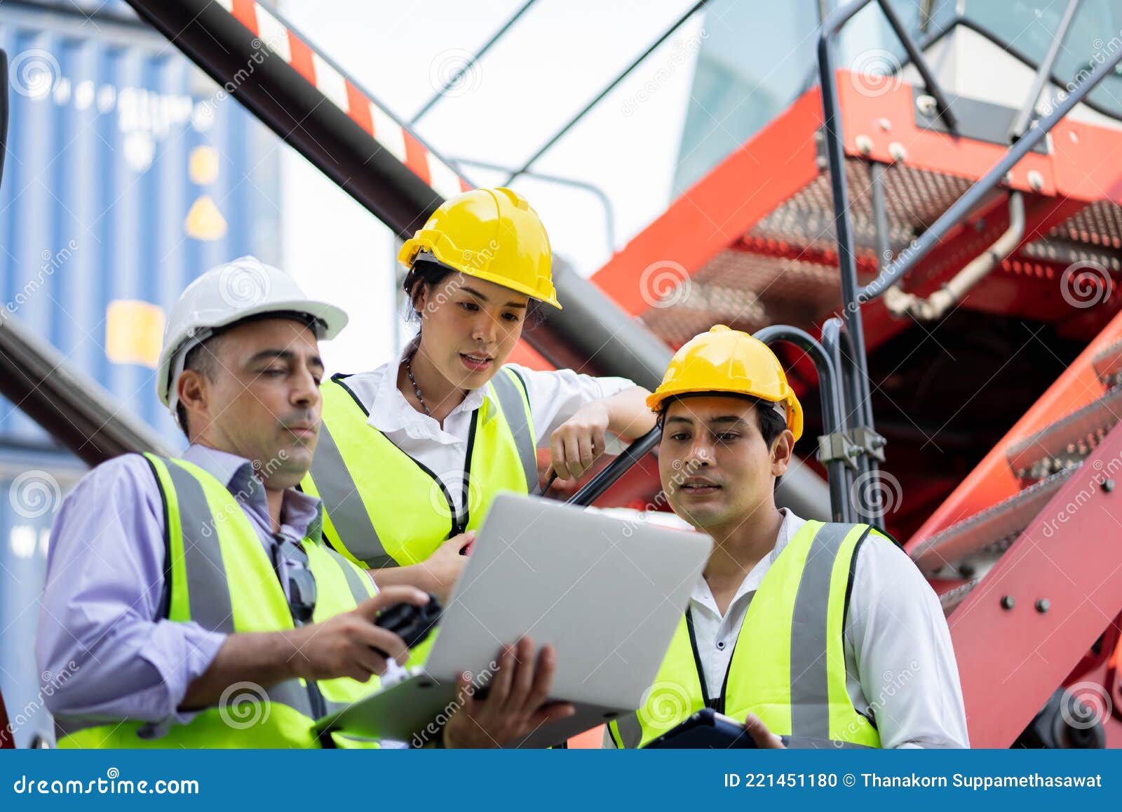 Warehouse Managers and Worker Working on Laptop in a Large Warehouse