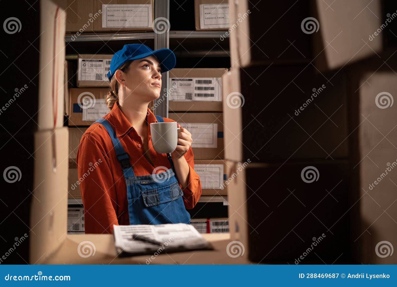 Warehouse Worker Has a Lunch Break Drinks Hot Coffee or Tea while