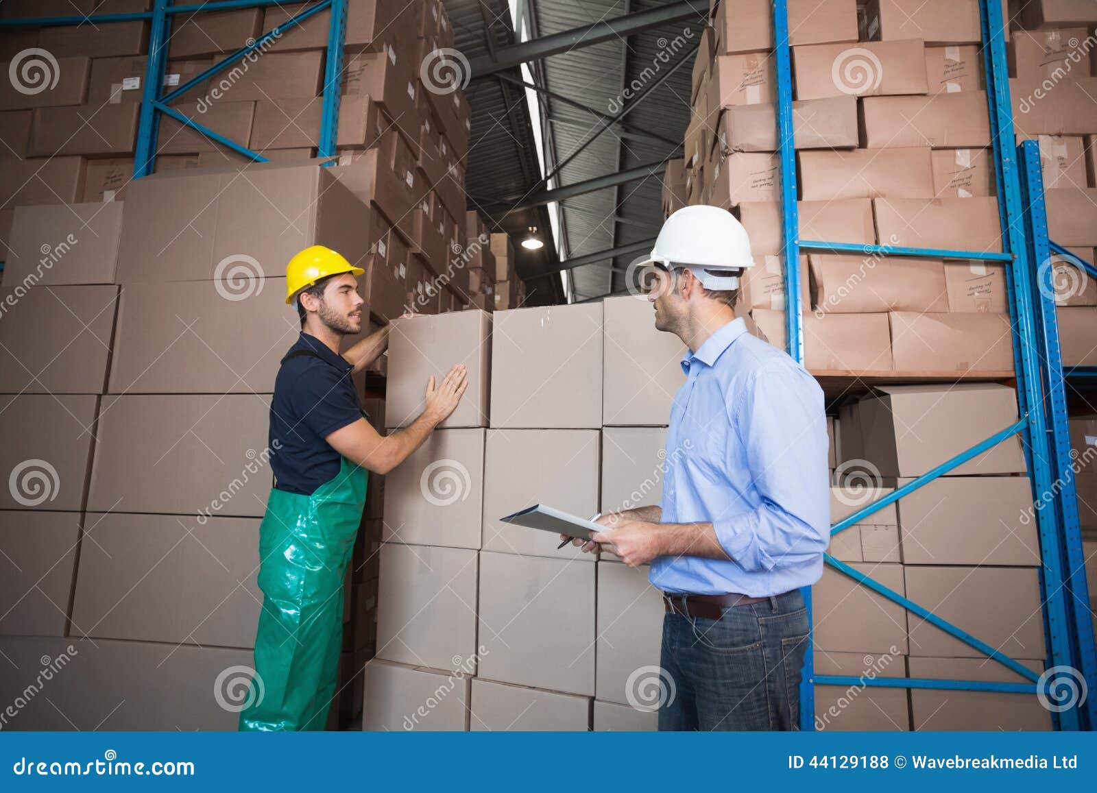 warehouse worker loading up a pallet with manager