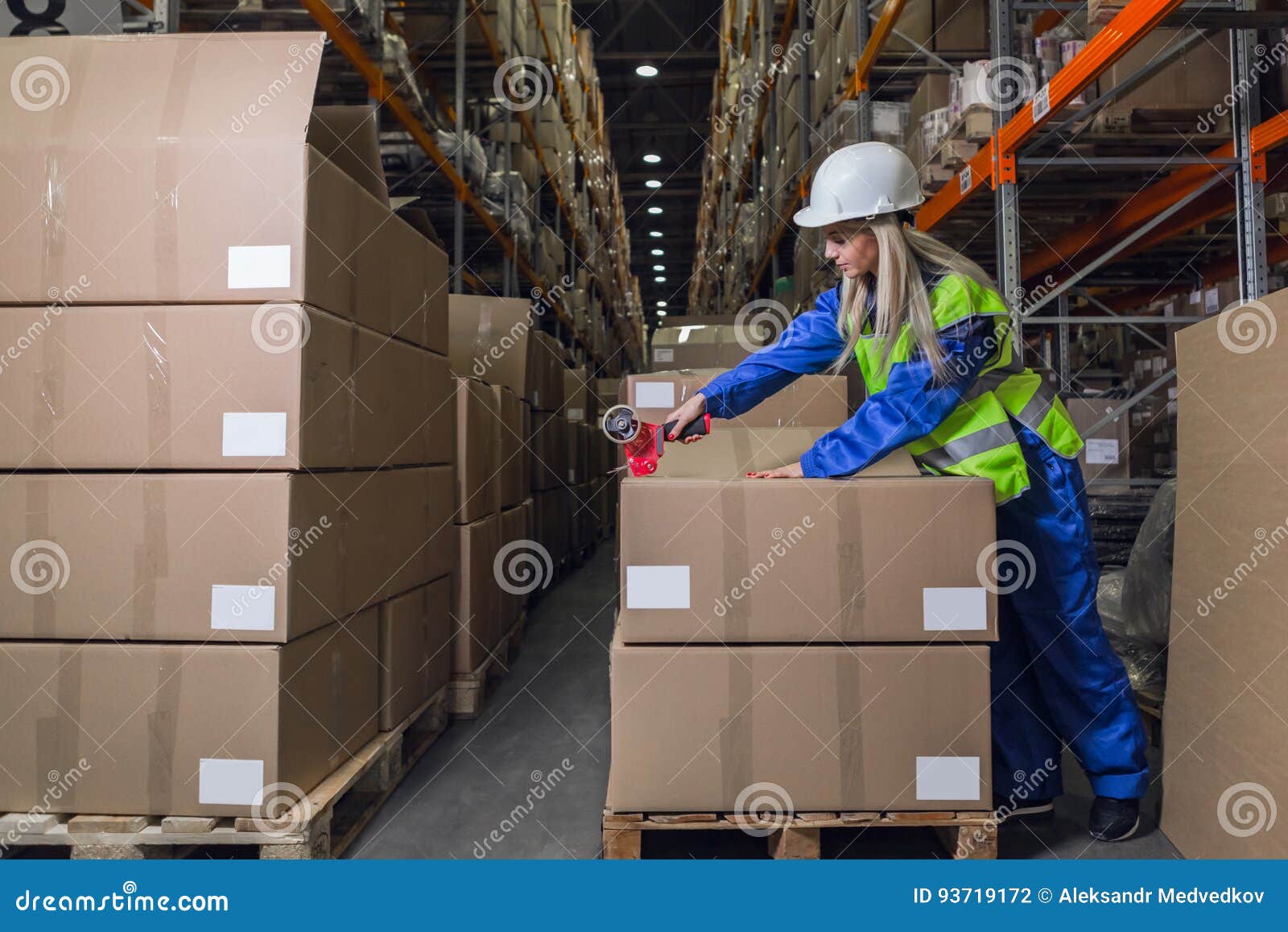 warehouse worker packing boxes in storehouse