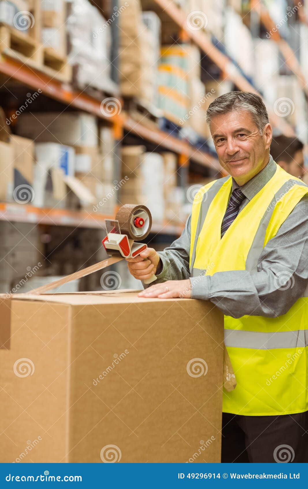 Warehouse Worker Sealing Cardboard Boxes for Shipping Stock Photo