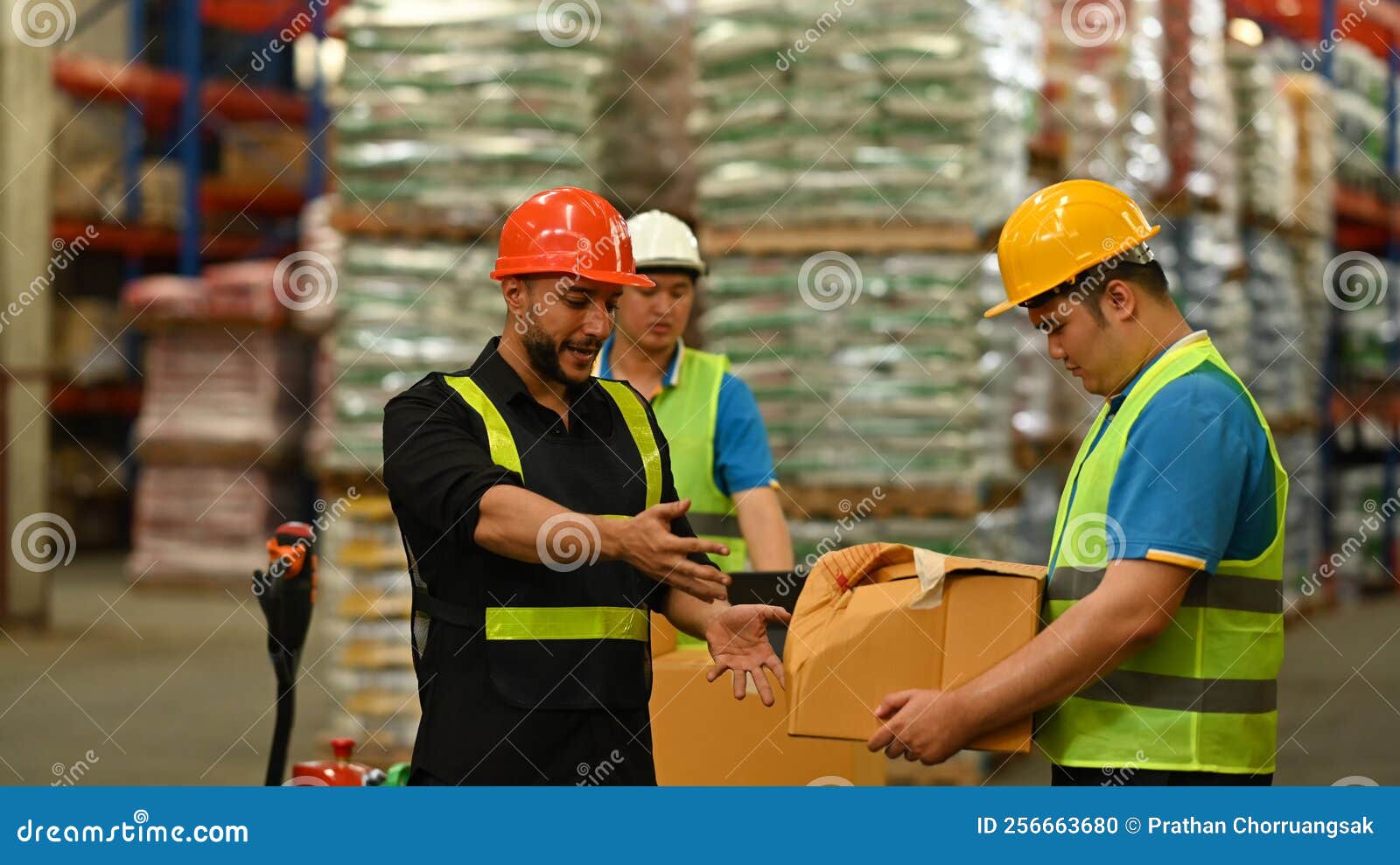 Warehouse Workers in Safety Uniform Working in Warehouse Full of Tall