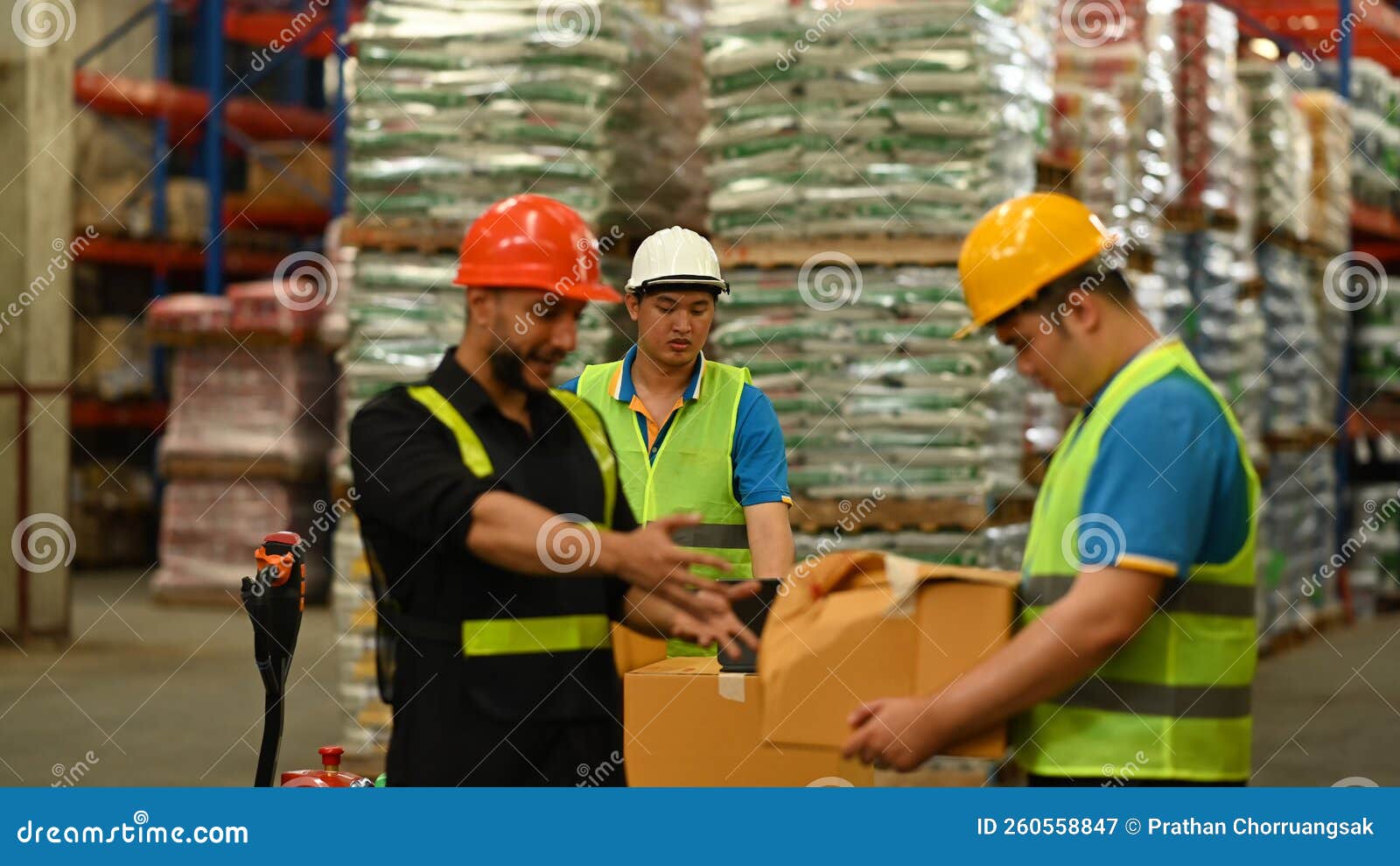 Warehouse Workers Working in the Retail Warehouse Full of Shelves with