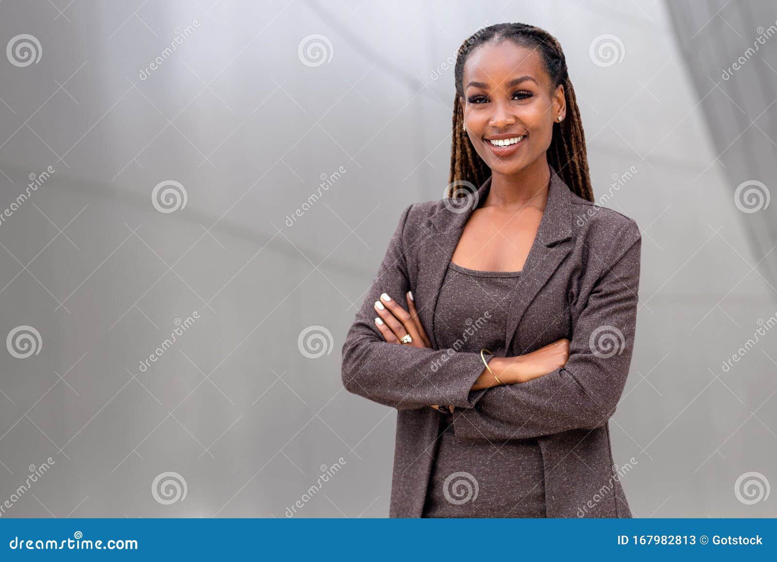 warm, friendly, beautiful cheerful african american executive business woman at the workspace office