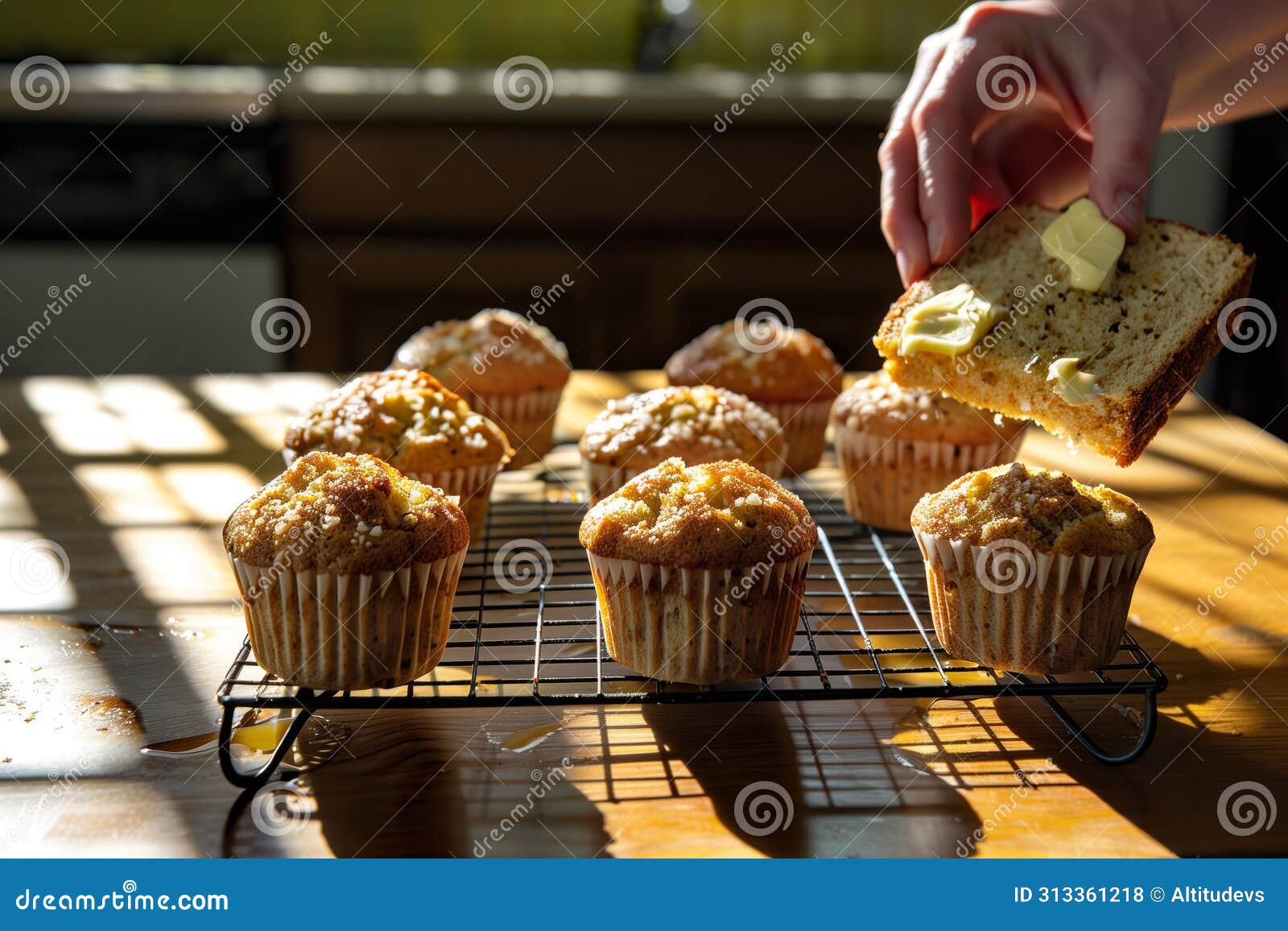 warm muffins on cooling rack, person buttering slice, sunbeam on table