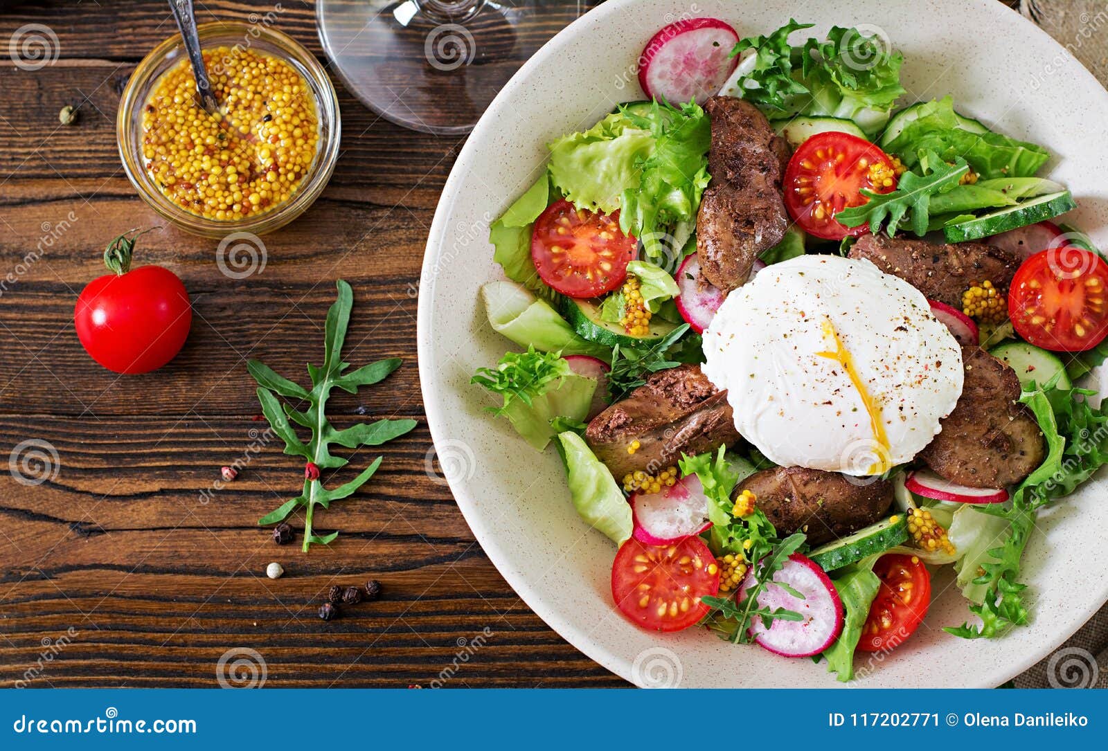 warm salad from chicken liver, radish, cucumber, tomato and egg poached