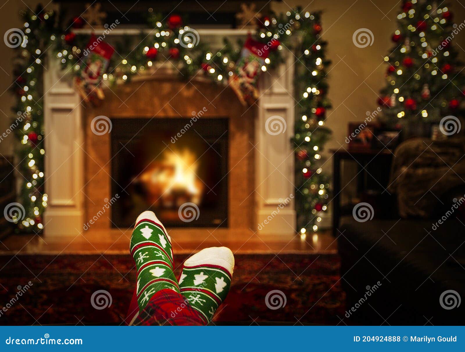 Warming Feet in Holiday Socks by Fire Stock Photo - Image of socks ...