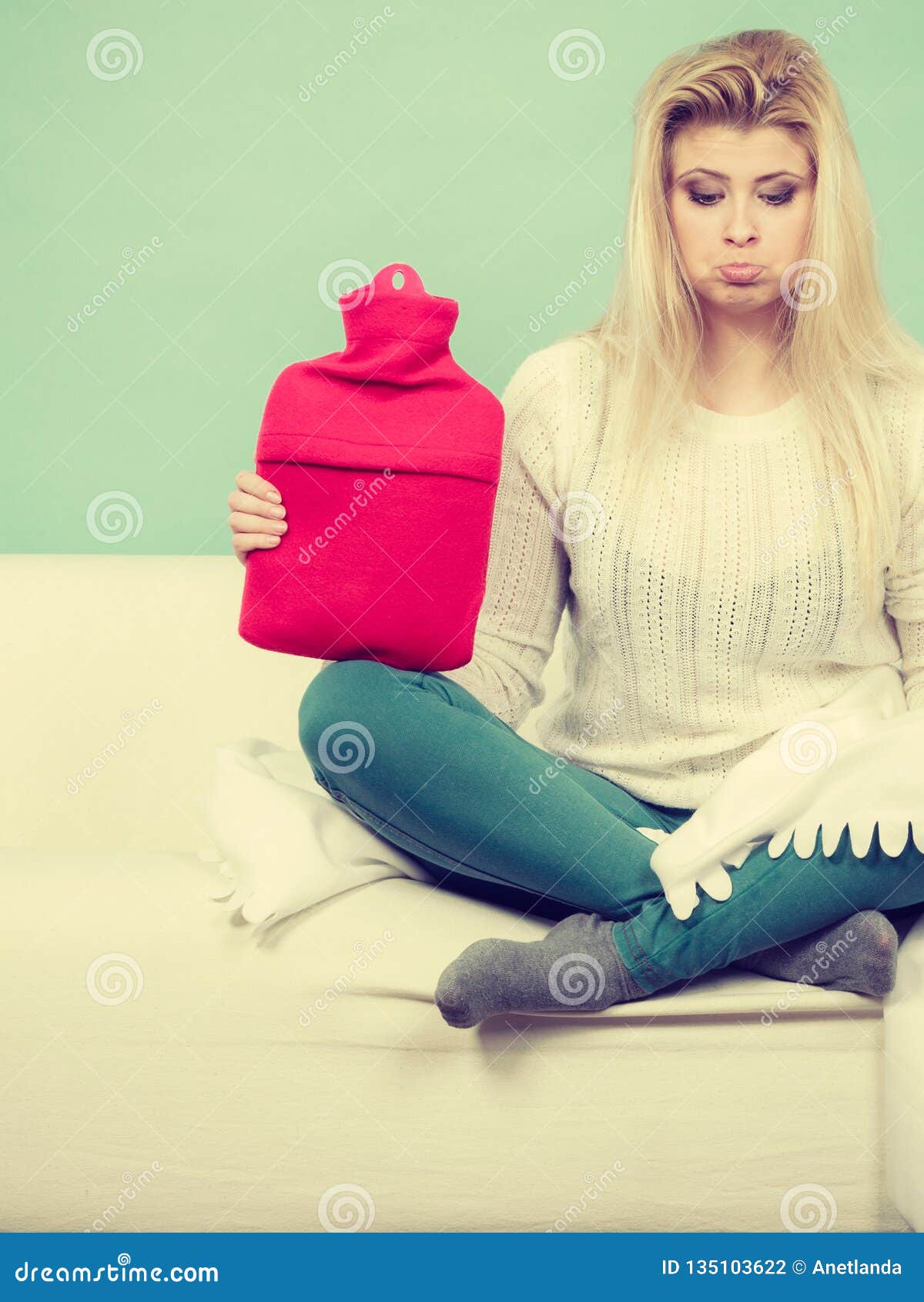 Woman Sitting on Couch Holding Hot Water Bottle Stock Photo - Image of  indoor, jeans: 135103622
