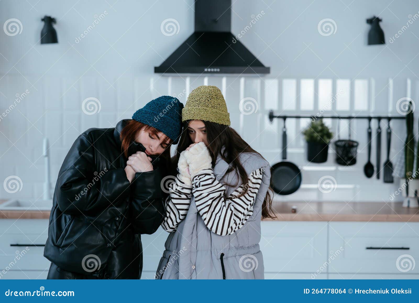 Warmly Dressed Women are Upset with the Heating Turned Off Stock Photo