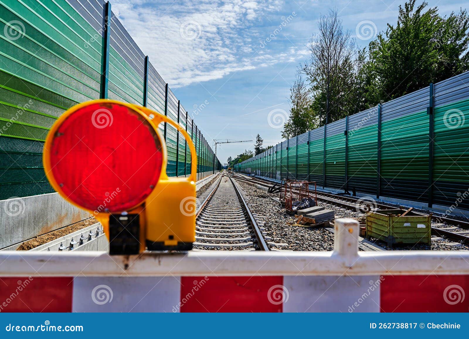 warning light on a barrier in front of the construction site for a new railway line