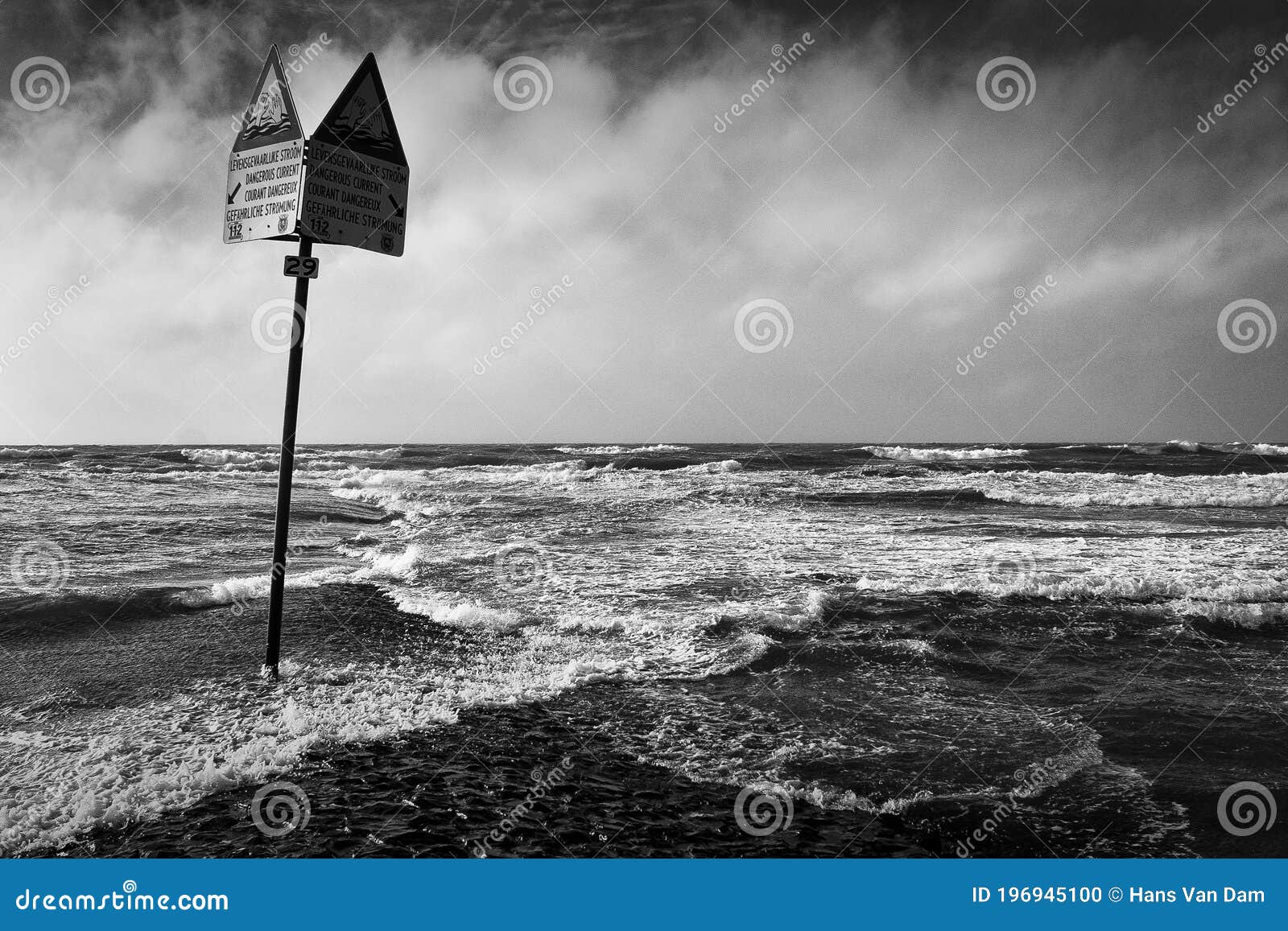 Warning at sea with clouds stock photo. Image of rocks 196945100