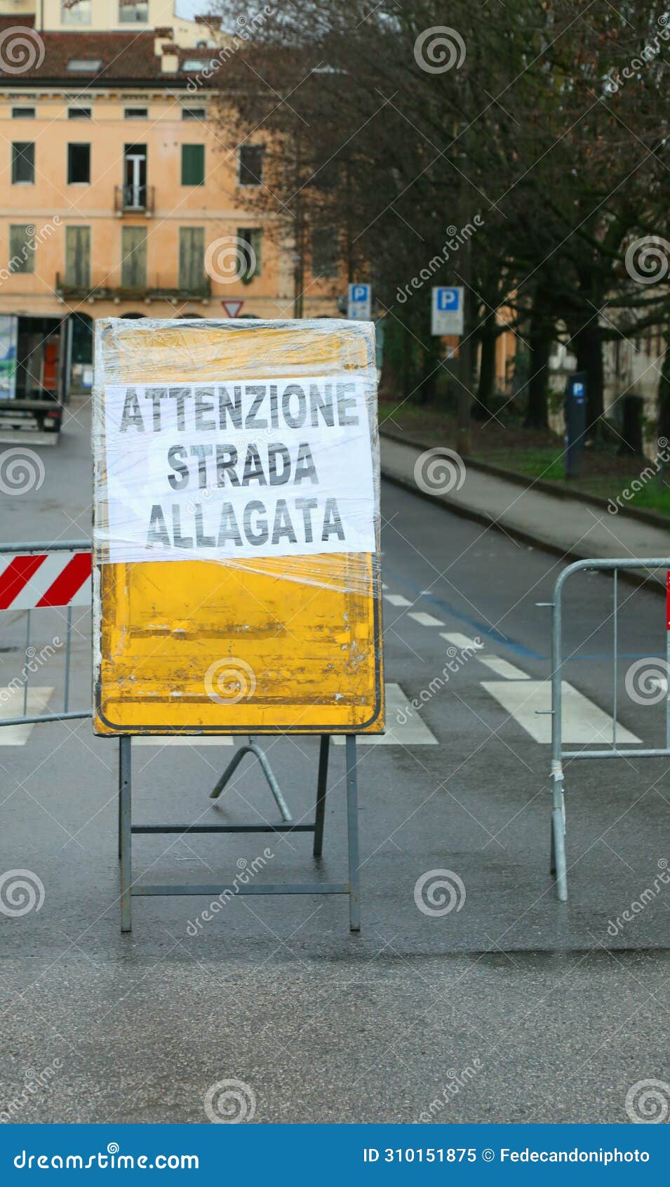 warning sign with text attenzione strada allagata in italian that means caution flooded road
