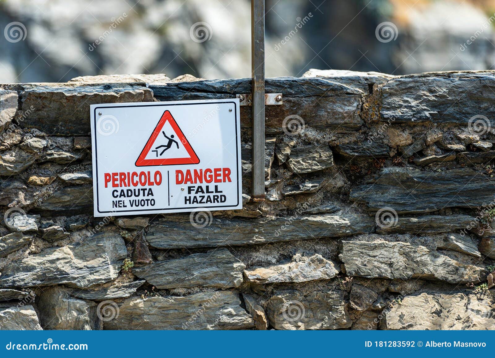 warning sign of fall hazard in english and italian - vernazza italy