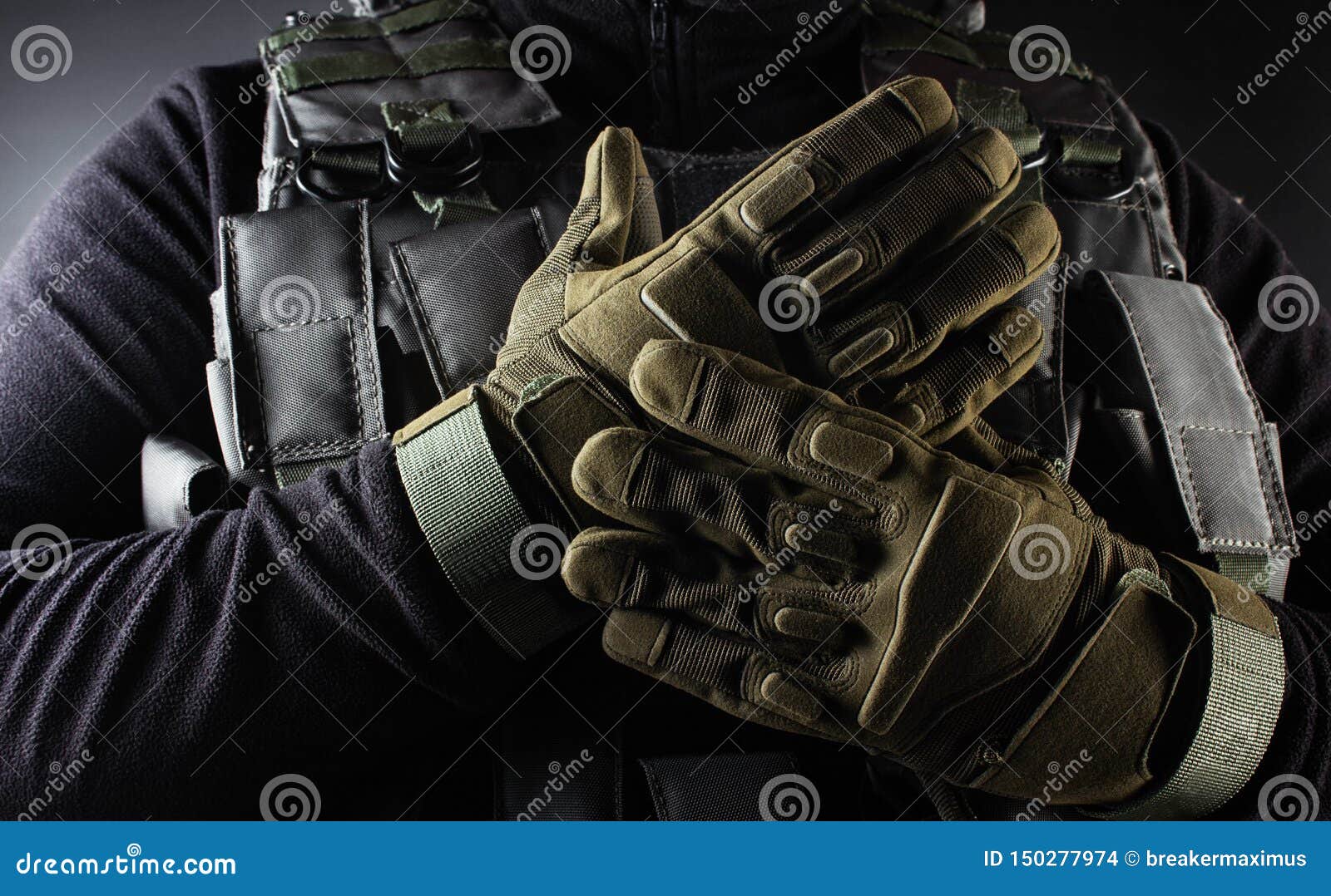 warrior soldier in tactical gloves standing front view closeup