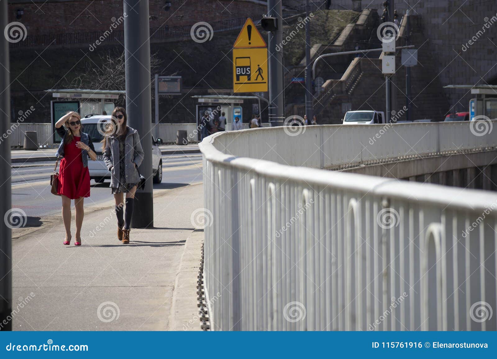Two Fashionable Girls Walk Across The Bridge Over The Vistula River