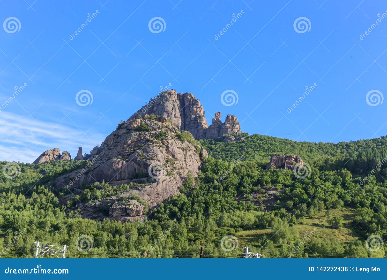 the steep mountain was treeless and surrounded by thick, deep forest