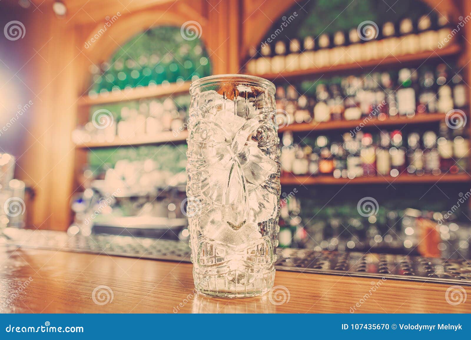 washed professional bar equipment and a glass filled with ice