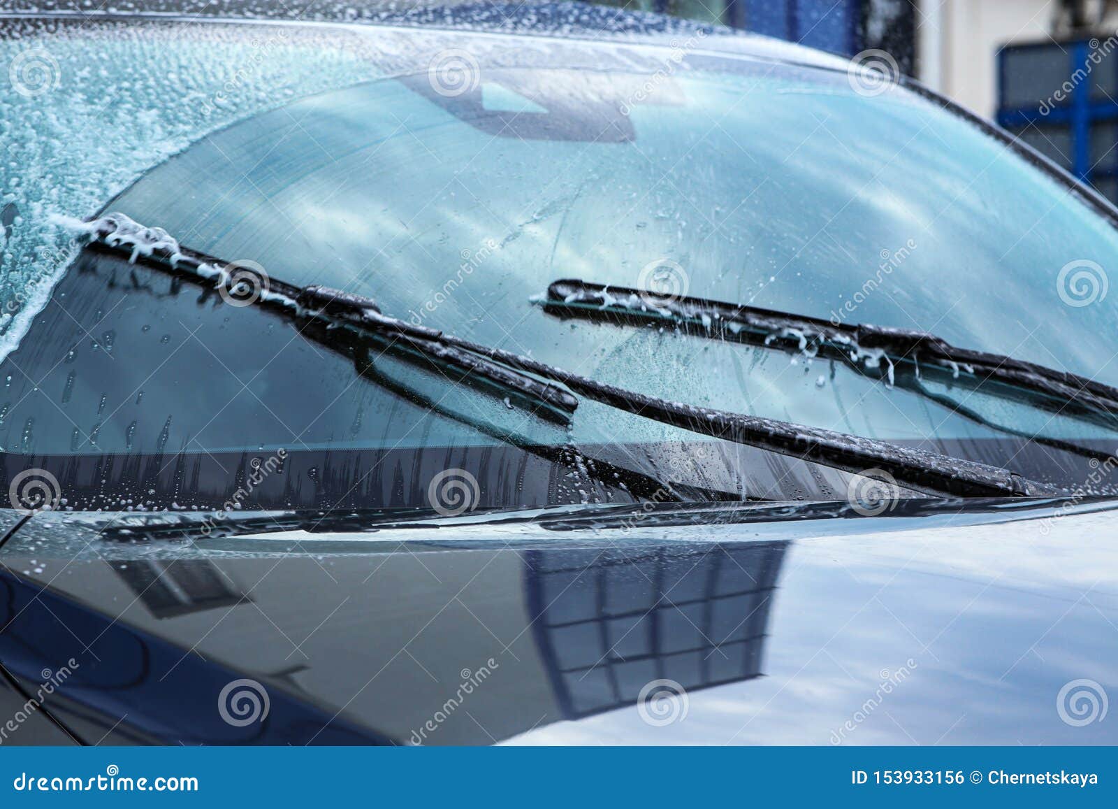 washing car windscreen with wipers and liquid