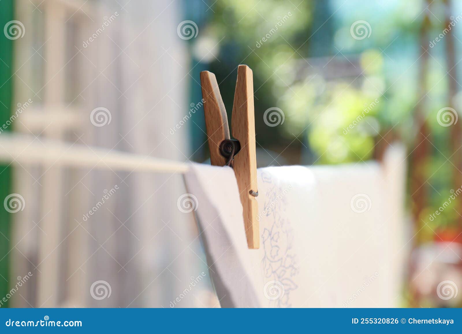 Washing Line with Clean Laundry and Clothespin Outdoors, Closeup Stock