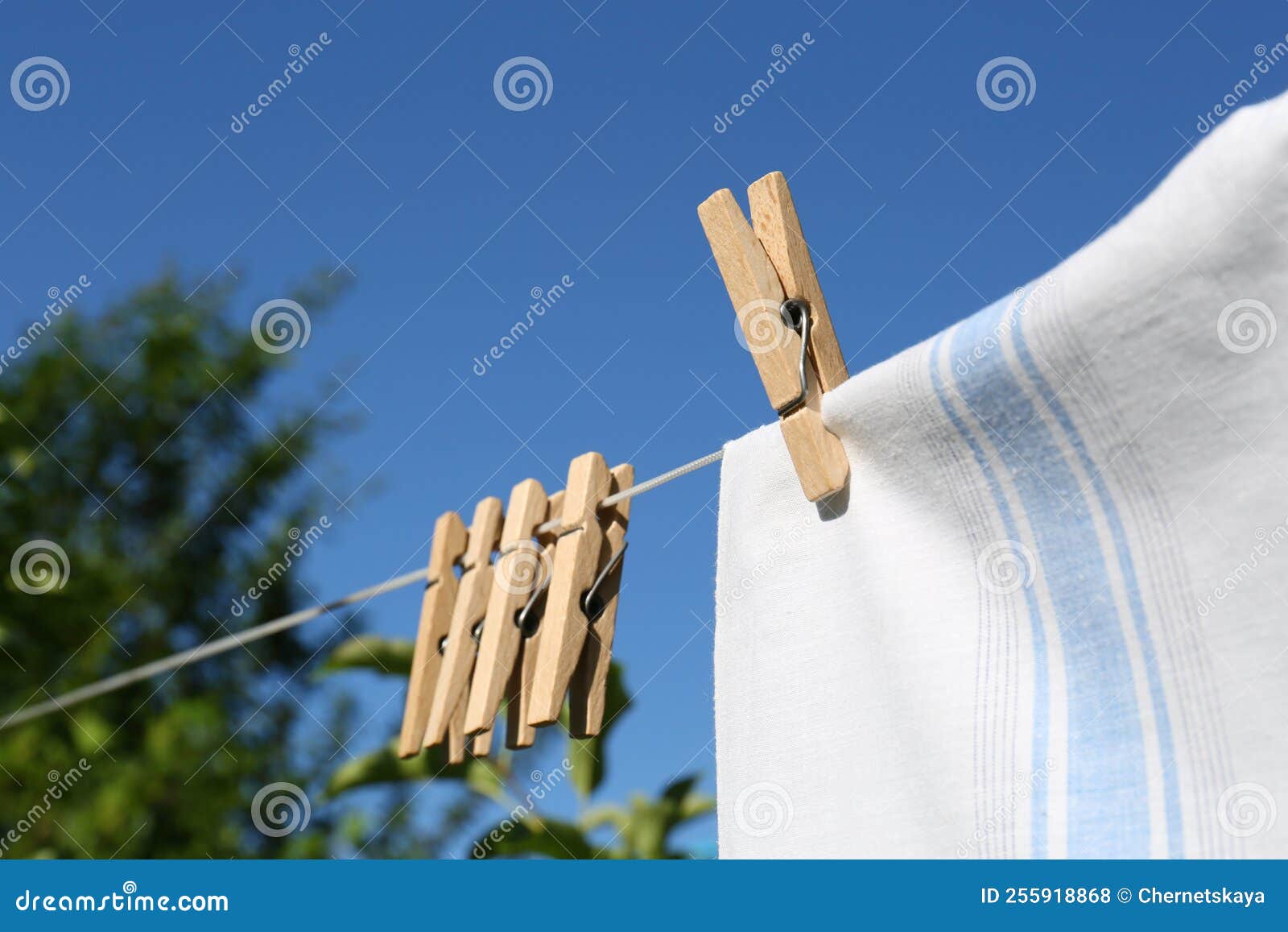Washing Line with Clean Laundry and Clothespins Outdoors, Closeup Stock