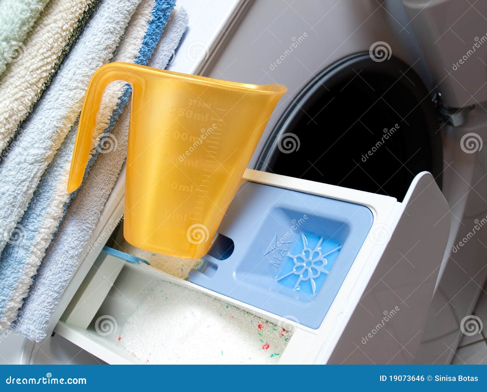 Blue plastic washing powder measuring cup isolated on white Stock Photo -  Alamy