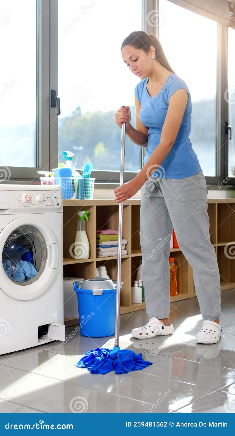 Washing Machine Leaking and Woman Mopping the Floor Stock Photo Image