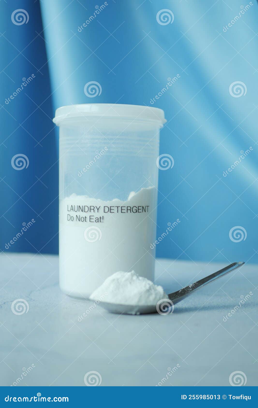 Washing Powder in Plastic Spoon and Container on Table Stock Image