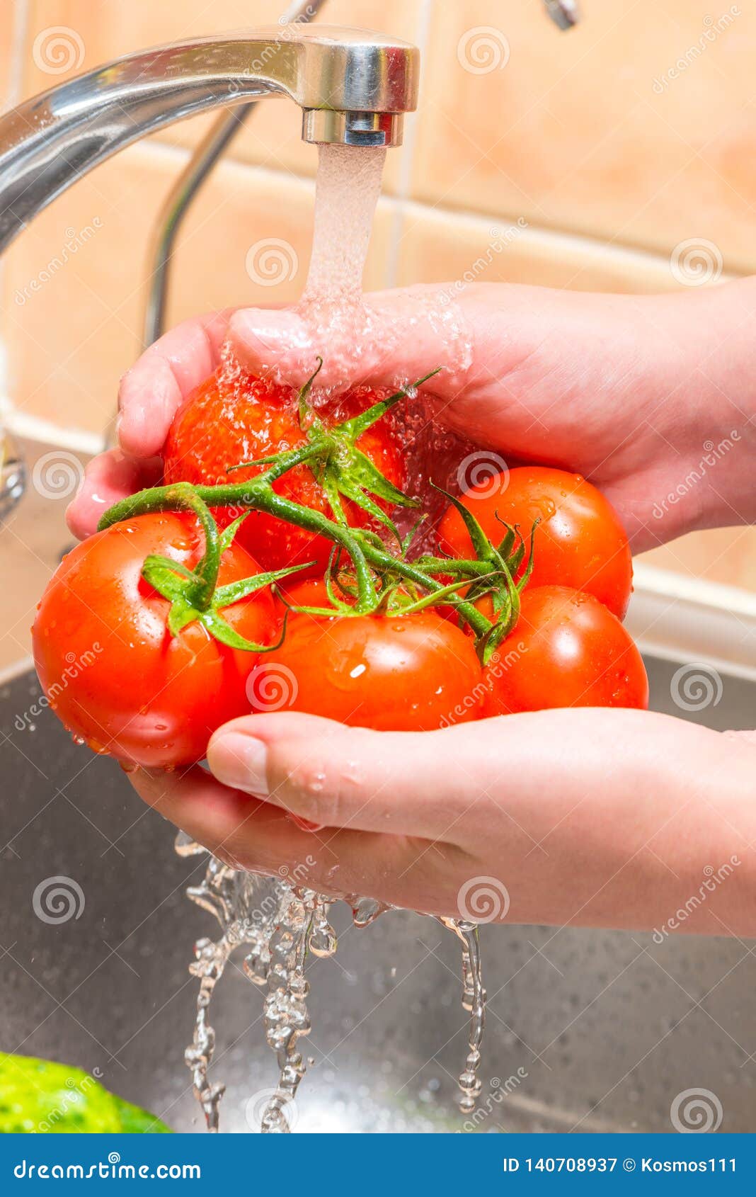 Washing a Tomato in the Kitchen Under Running Water Stock Image Image