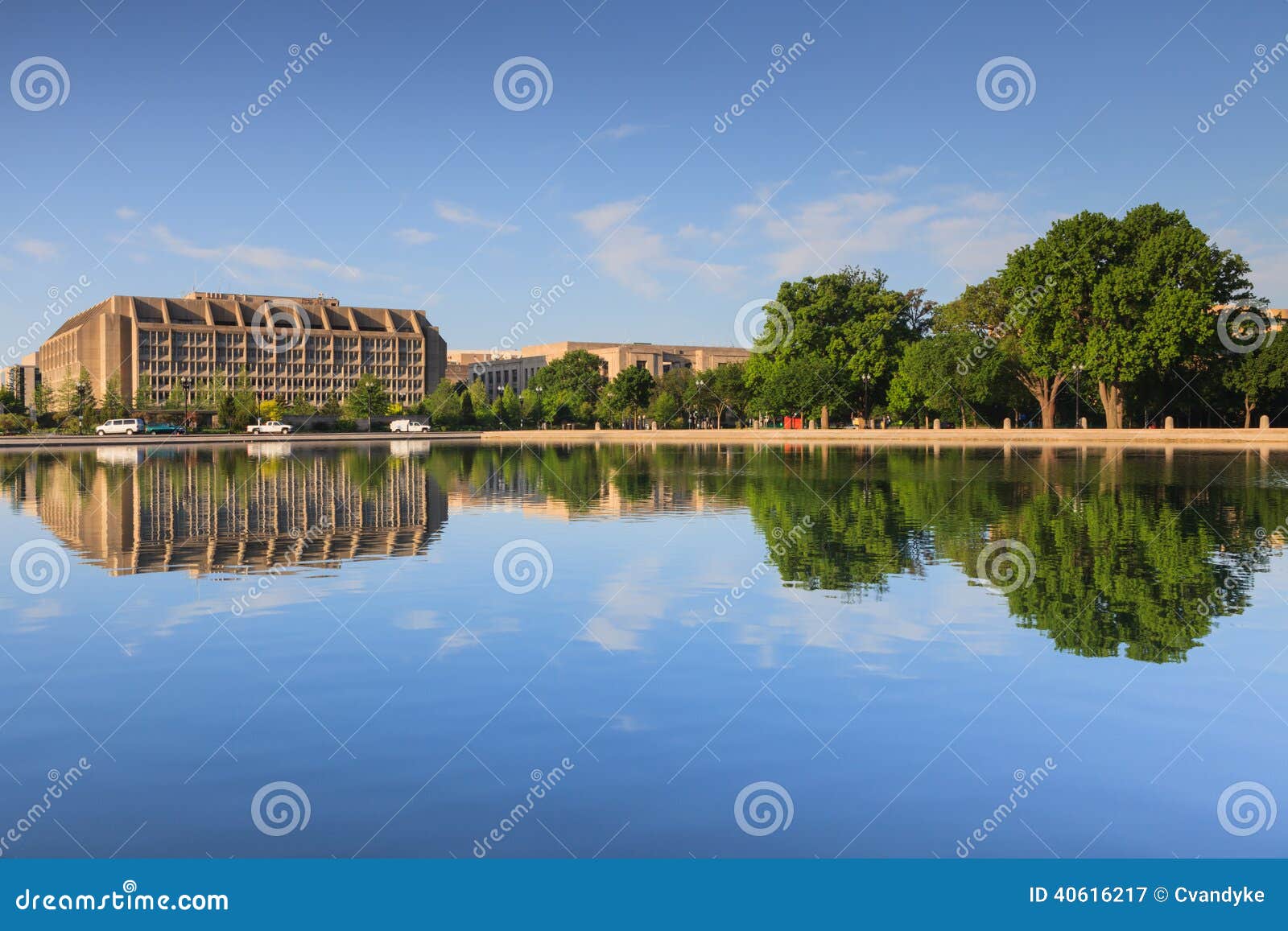 washington dc office building mirrored in capitol reflecting pool