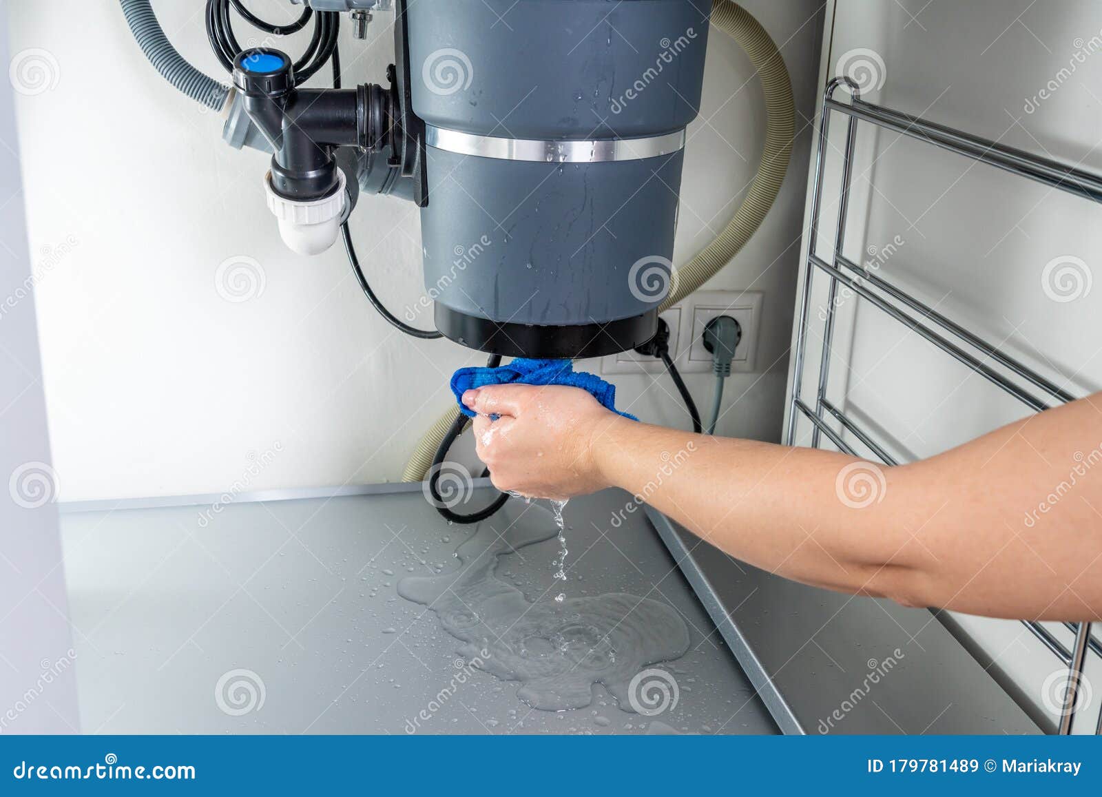 waste disposal leak under a sink, broken garbage chopper