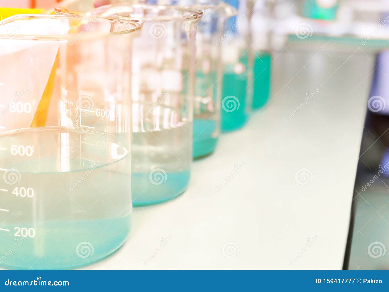 waste water sample in beakers coagulation and flocculation method with copper sulfate and using jar test for forming precipitation