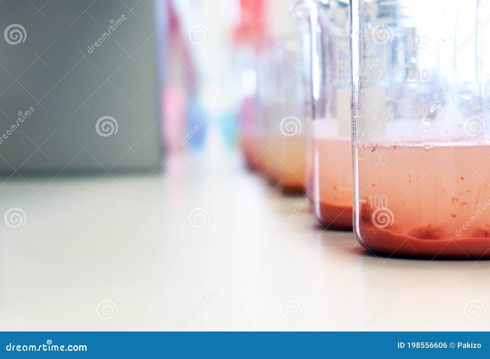 waste water sample in beakers coagulation and flocculation method with ferric chlorine and using jar test for forming precipitate.